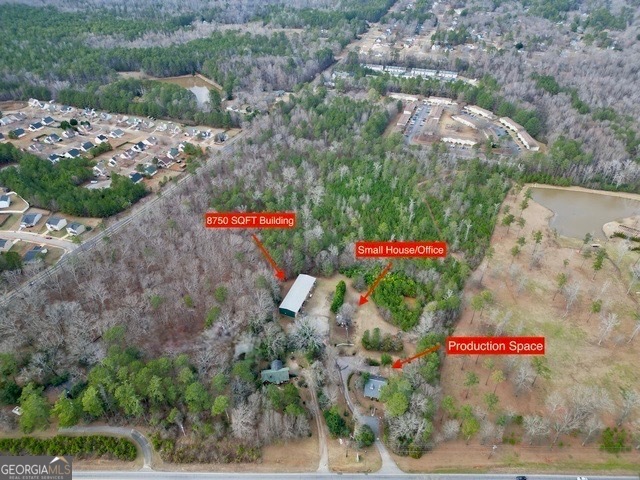 Prime Commercial Opportunity in Griffin! Located in a rapidly growing area of Griffin, this expansive commercial property offers exceptional potential for investors, developers, and business owners. The property features four buildings, including a nearly 8,000 sq. ft. structure, a converted office space, and a production facility, With a fire hydrant on-site, and a retention pond already in place, the infrastructure is well-prepared for a variety of commercial uses. Its strategic location, bordering Mystic Acres Event Venue and other Commerical developments, provides convenient access to Griffin, Highway 362, and Highway 19/41. Offered at $600,000, this property presents a rare opportunity to secure valuable commercial space in a growing market. Zoning is C-1B which provides for variety of uses. Property is a working business, do not approach and disturb employees. Neighboring property w/ rental home could also be purchased, inquire with Listing Agent for more details.