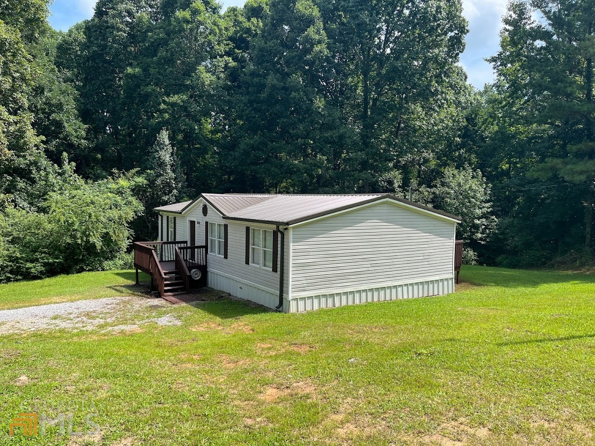 This home is move in ready with a new HVAC system, new paint, new lighting, new roof and new gutters. The home offers a large corner lot, split bedroom plan and open views from the kitchen to the living room area. The owner has the titles and will provide a structural engineering letter for an applicant needing FHA financing.