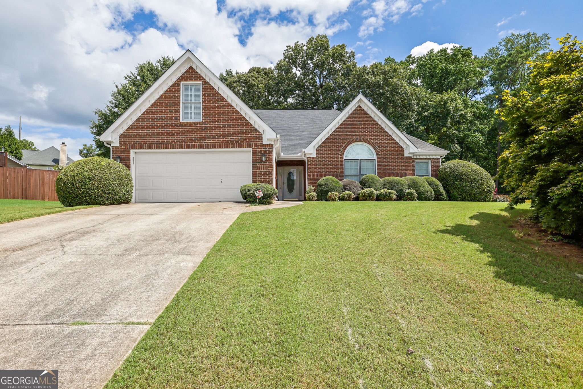 Welcome to this beautifully maintained 4-bedroom, 2-bathroom home ideally situated just minutes from Scenic Hwy, GA-20, Sugarloaf Parkway, and a wide variety of local dining and shopping options in Lawrenceville. Nestled on a spacious and beautifully landscaped lot, this home offers the perfect balance of comfort and convenience. The main level features a generously sized primary ensuite, providing easy access and privacy. Additional highlights include a 2-car garage and ample living space for family and guests. Whether you're relaxing indoors or enjoying the expansive yard, this home has something for everyone. Don't miss the opportunity to own a home in one of Lawrenceville's most accessible and desirable locations! Discounted rate options and no lender fee future refinancing may be available for qualified buyers of this home