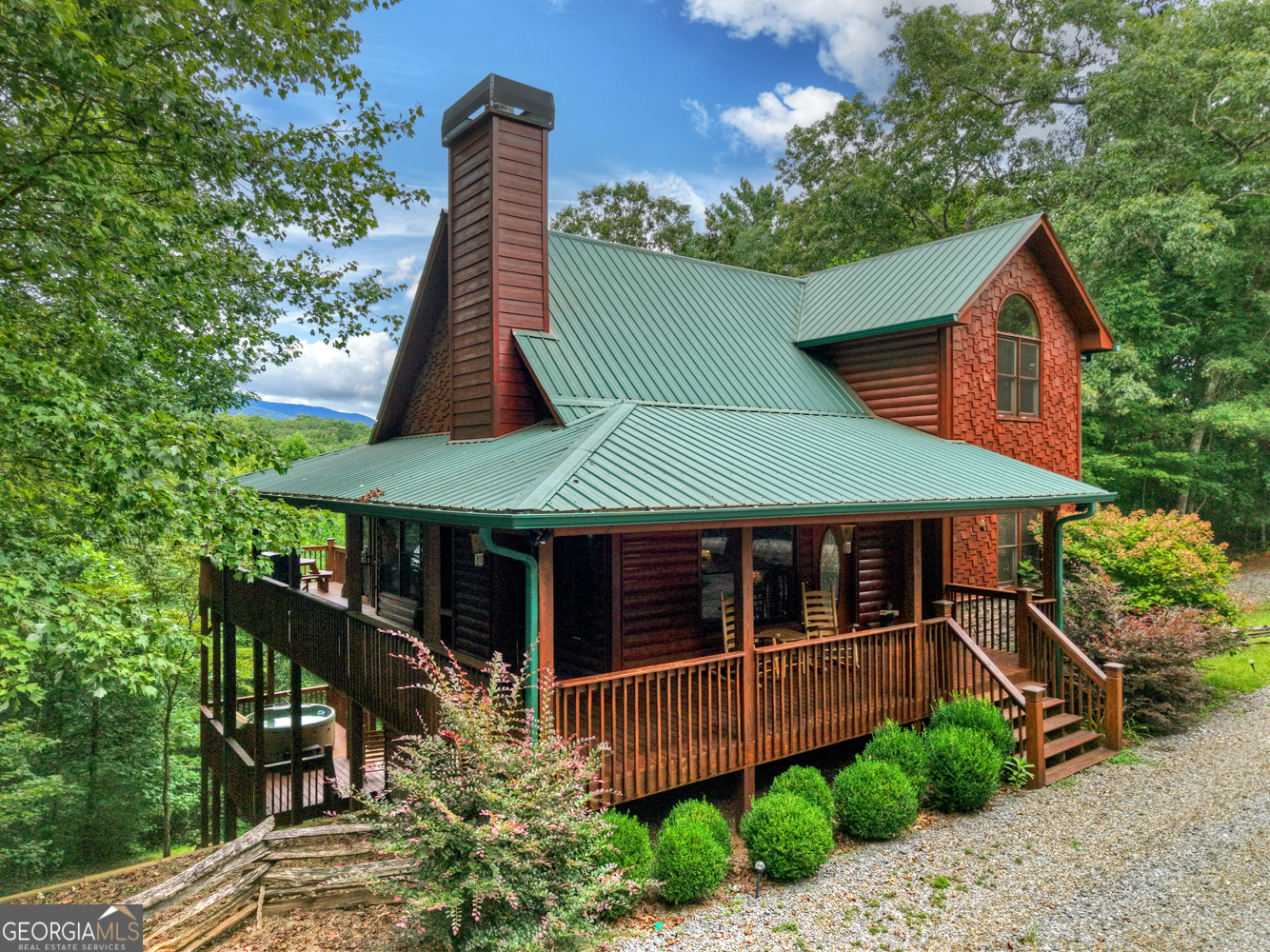 Fully furnished and turnkey.... This adorable cabin on 3.05 acres in Ellijay, GA, is the perfect blend of mountain charm and modern comfort. Just 5 minutes from Roo Mountain Winery and Ellijay Mushrooms Farm, it boasts a wraparound porch, a screened back porch with an outdoor fireplace, and mountain views. Inside, you'll find a cozy living room, dining area, granite kitchen with stainless steel appliances, and a main-level primary suite with porch access, dual closets, and a spa-like bath. Upstairs offers a loft with built-in bunks and a second primary suite with a private deck. The finished basement is an entertainer's dream, with a bar, game room, and space for an extra bedroom-plus a hot tub on the lower deck for the ultimate relaxation. Whether you're seeking a weekend escape or an income-producing property, this cabin delivers it all!