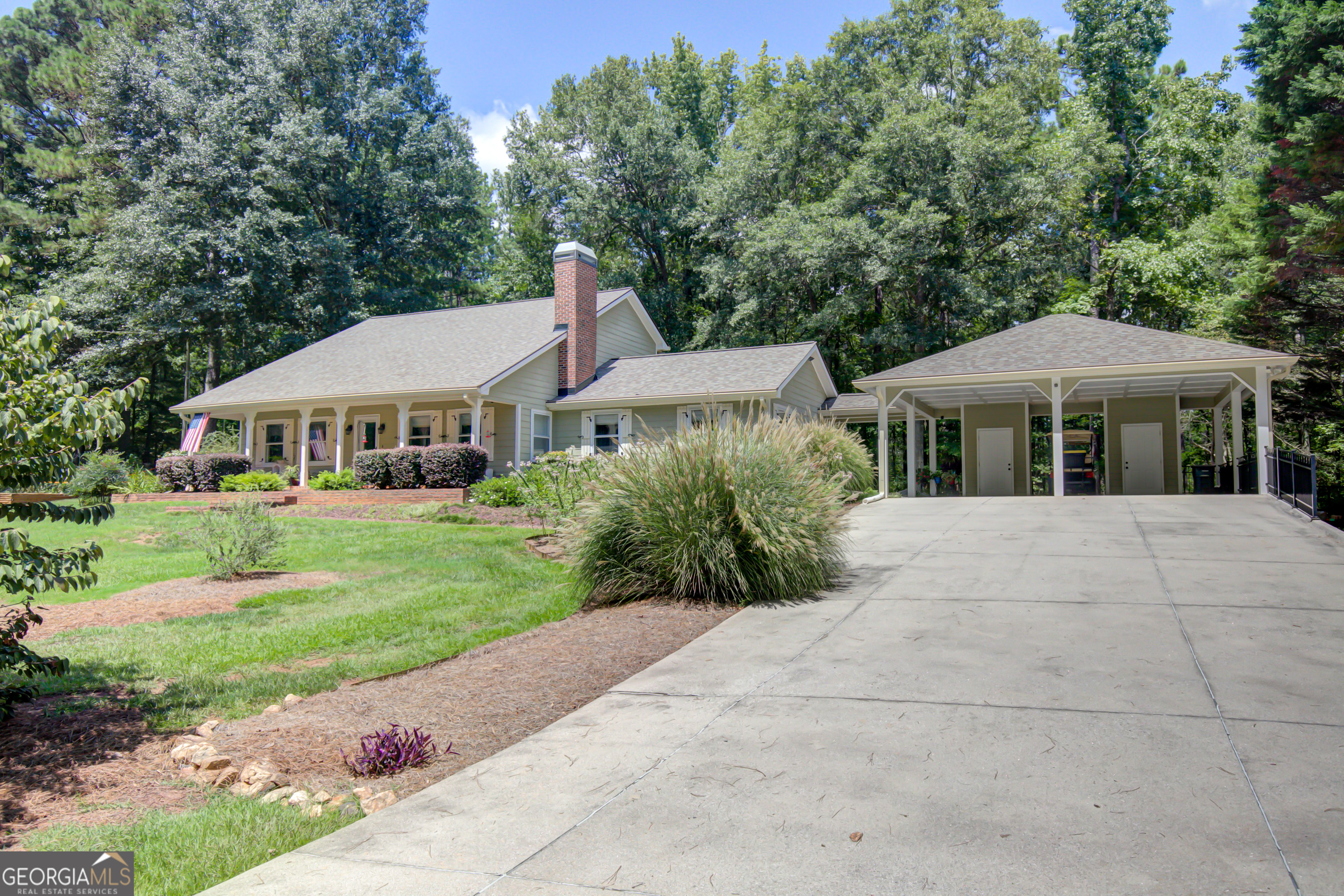 Tucked away in a quiet COWETA COUNTY neighborhood with no HOA and only 9 homes on one road is this exceptionally well maintained and charming home ready for you to move right in! You'll love the hickory flooring throughout the first floor - highlighted by the natural light that flows through the windows on every side. The living room is cozy with its wood burning fireplace and gives access to the second floor that boasts 2 big bedrooms with walk-in closets and full bath to share. The owner's suite is on the main floor and has a full tile walk-in shower, as well as 2 closets. Granite counters, soft close cabinets & drawers, stainless steel appliances and a pantry with additional storage are welcome additions to the updated eat-in kitchen. Imagine the entertainment possibilities in the huge family room. The carport features 2 vehicle parking and 2 closets for storage. The one acre lot is just as cared for as the home - there's a veggie garden, a large lawn area punctuated by areas with blooming plants and shrubs for year-round color. Enjoy the view from the rocking chair front porch or the quaint brick patio or wooden deck in the backyard. Nothing to worry about with this one - already inspected and appraised, it has 2 year old roof, a repair & retreat termite warranty, septic has been serviced, comes with storm windows & doors, and security system. You will be hard pressed to find a home in a better location - it has convenient access to I 85, Canongate golf course and is less than 20 minutes from Trilith, Hartsfield, the new home of USA soccer, Peachtree City & Fayetteville. AND it is zoned for Canongate, the new Blake Bass Middle School & Northgate school.