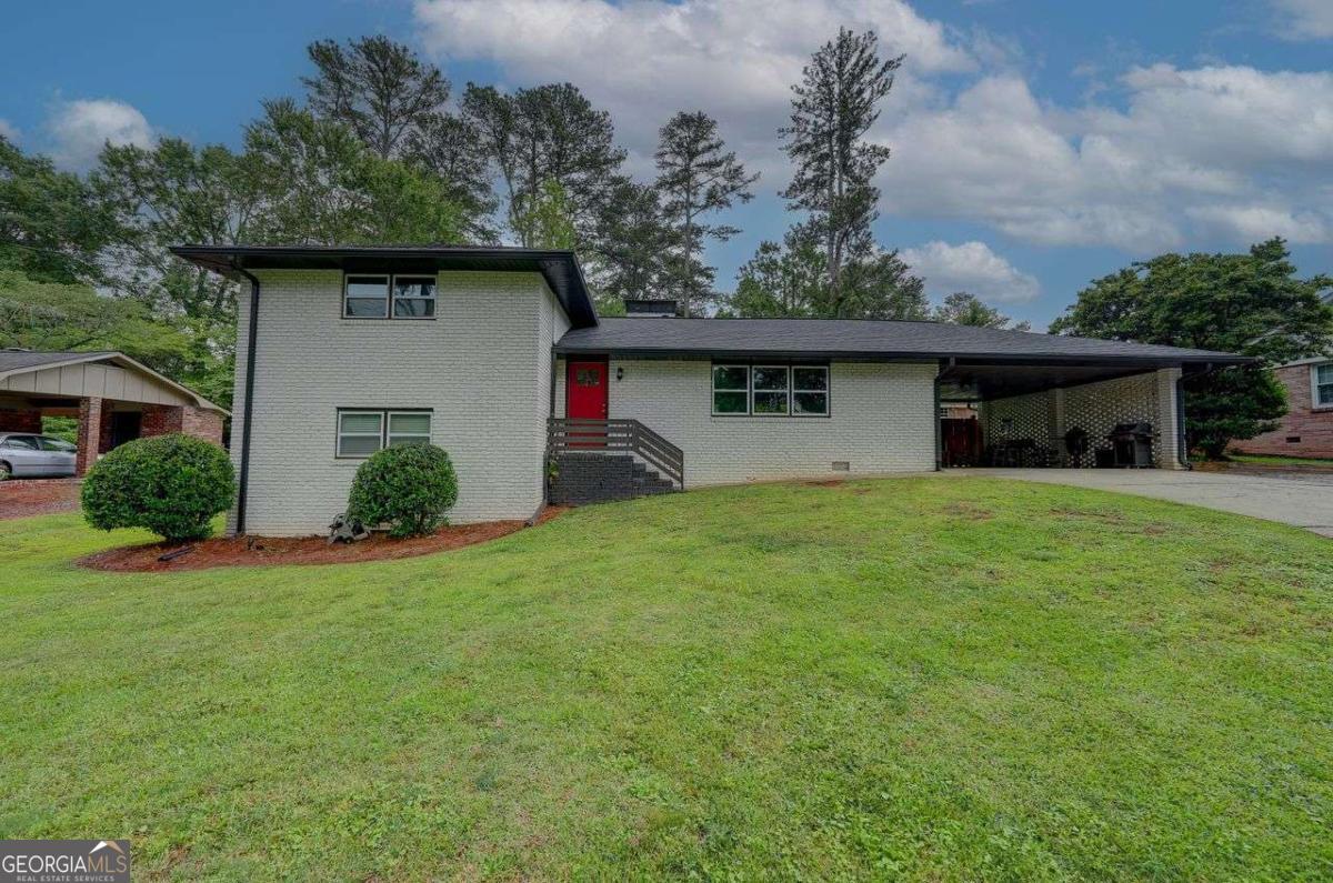 This 4-bedroom, 2-bath home in Marietta is just minutes from I-75, making your commute to the city a whole lot easier. The classic four-sided white brick exterior sits on a generous lot, and inside, you'll find an open layout filled with natural light. The family room flows into a kitchen with granite counters, stainless steel appliances, and a casual dining area with fireplace. Sliding glass doors open to a large concrete patio and a beautifully maintained, fenced backyard with a storage shed. The spacious bedrooms and double-vanity bathrooms offer both comfort and functionality. With plenty of windows throughout, this home feels bright and welcoming all day long. You're also close to shopping, dining, and more! NEW ROOF, HVAC AND WATER HEATER ONLY 4 YEARS OLD. This one checks all the boxes - take a look before it's gone!