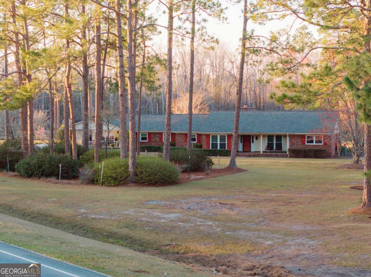 ONE-OWNER property with almost 15 ACRES! Spring-fed POND! Over 3400 heated square feet sprawls across this brick ranch home! 3 bdrm/3bath home with 2 office areas. Entering the home from the TRIPLE carport, entertain your guests in the LARGE SUNROOM with bar and tv. Secondary sunroom also! Separate living room with masonry fireplace is also very spacious! Two TANKLESS water heaters. NEW ROOF. The main bedroom boasts a walk-in closet, dual vanities, tub and separate shower, PLUS a 2ND den with gas fireplace, counterspace and its own mini-fridge. Stainless steel appliances including Kitchen-Aid dishwasher, under-cabinet lighting for the counters, trash compactor, sink disposal, and tons of strong cabinets that have stood the test of time. The laundry is huge with plenty of cabinets, pantry shelving, a double stainless steel sink, and space for an additional refrigerator or freezer. Lots of exterior storage buildings and work space. Too much to list! Call me!