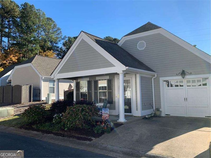 Welcome to the desirable Cottages at Towne Lake, a private end-unit in Woodstock's favorite community offering serenity and a spacious atmosphere. This active adult community welcomes all ages - there are no age restrictions. Enjoy wonderful amenities including a community pool for relaxing swims and social gatherings. Step inside to an inviting entry leading to the bright family room with a cozy fireplace, perfect for warm evenings. The open kitchen features ample cabinet and counter space, making meal prep a pleasure. The generous master suite includes space for a home office or quiet reading nook. A second bedroom offers convenience with direct bathroom access. Step outside to a large garden patio bursting with established plants and vibrant flowers for year-round color - your own outdoor oasis. Enjoy quiet living, privacy, and all the comforts of a well-designed home in a community close to shopping, parks, and top-rated schools.