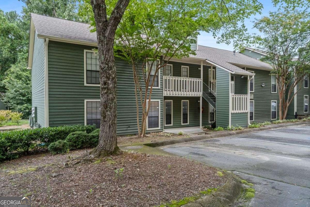 Located in the sought-after Vinings area of Atlanta, this charming 2-bedroom, 2-bath condo offers the perfect blend of comfort, style, and convenience. Just minutes from Downtown Vinings, The Battery, Braves Stadium, and the vibrant Westside, you'll enjoy easy access to shopping, dining, and entertainment. Situated in a gated swim/tennis community, this home provides a secure and welcoming environment with resort-style amenities. Inside, you'll find a thoughtfully updated interior featuring a renovated kitchen with quartz countertops, stainless steel appliances, a cozy eat-in area, and a formal dining space. The great room offers built-in bookshelves, new lighting, and new LVP flooring. This well designed floorplan also offers a sunroom which makes an ideal space for a home office or reading nook. The spacious owner's suite will not disappoint, it includes a private bath, walk-in closet, and a sliding door that provides access to the extended patio. Enjoy the fenced-in backyard providing privacy and outdoor living space rarely found in a condo. With its modern upgrades, inviting layout, and unbeatable location, this home is truly a must see.