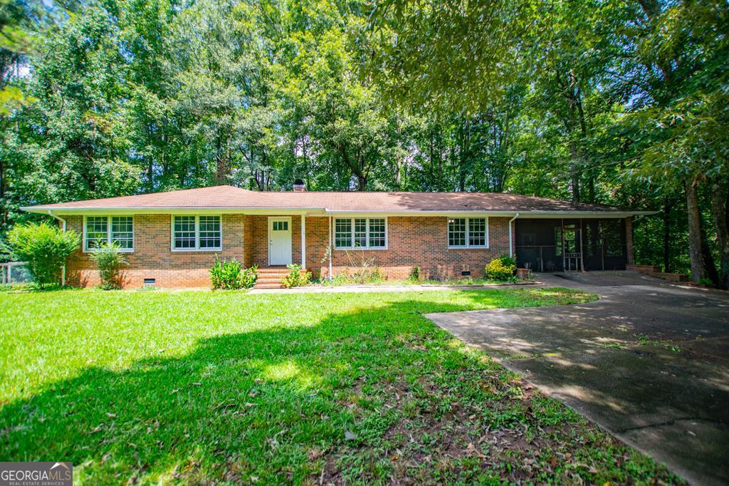 This full-brick 3 bedroom, 2 bath ranch sits on just over an acre in the Bowdon school district, but what's outside may be even better than what's inside. A strong, clear creek runs along the edge of the property-perfect for kayaking, tubing, swimming, or reeling in catfish that don't require any fish tales to impress. The yard itself is a playground for all ages, with a private practice range for target shooting and room to roam. Wildlife is a daily guest here-deer grazing at dusk, herons gliding low, even a baby owl that hatched right on the property. Inside, you'll find a solid, timeless brick home ready for your touch. Priced well below market value to allow for a new roof, this home offers both instant savings and endless potential. Seller is also purchasing a one year home warranty for the new buyer!! This isn't just a house. It's where weekend memories are made, where kids learn to fish, and where the simple things-like the sound of a heavy-flowing creek-remind you why you wanted land in the first place.