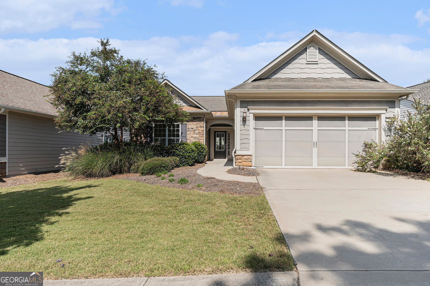 A beautiful craftsman style ranch home available and located in the desirable Sun City Peachtree community. As you step through the front door, you are greeted by a spacious foyer that sets the tone for the entire home. The open concept includes the living room, dining room and kitchen making it ideal for intimate gatherings. Living room with wood flooring and a corner fireplace, large dining area and open kitchen including granite countertops, stainless steel appliances, a large pantry and plenty of cabinets. A cozy sunroom leads outside to a covered porch for relaxation. The primary suite is a spacious retreat with an ensuite bathroom featuring dual vanities, a soaking tub and separate shower. Large walk-in with custom shelving. Second bedroom with easy access to hall bath. Large laundry room with cabinets and sink leading to the 2-car attached garage. Freshly painted throughout making it move in ready. Don't miss out on this gem. Call today and schedule your showing!