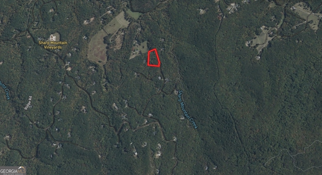 Tuck into the gated Preserve at Sharp Mountain with this rare 3.82-acre homesite on Creekside Dr-serene, wooded, and ready for your vision. Gentle topography offers multiple build sites, with electricity, public water, cable, and phone available at the road. The community embraces nature over noise: miles of hiking and nature trails, pocket parks and green space, a nature pavilion, waterfall areas, a bird sanctuary, and even a butterfly garden create a true mountain-retreat lifestyle. Annual HOA is $1,500 and helps maintain the roads, trails, and conservation areas that keep the Preserve pristine. Life in Jasper blends small-town ease with real economic momentum. Pickens County's long marble heritage still anchors local identity-with quarry tours every fall during the Georgia Marble Festival-and today's job base spans manufacturing, materials, and light industry alongside a growing small-business scene. It's a community where entrepreneurs, trades, and remote professionals all plug in easily. Weekends write themselves here. Five minutes up the ridge, Eagle's Rest Park on Mt. Oglethorpe serves up sweeping views, picnic spots, and family-friendly trails. A short drive puts you at Amicalola Falls State Park-home to one of the tallest cascades in the Southeast and a gateway to the Appalachian Trail-and stroll-worthy Gibbs Gardens in nearby Ball Ground. Historic small towns like Talking Rock and Blue Ridge make for easy day trips, while Atlanta's culture, sports, and airports are roughly an hour away via GA-515/I-575. The Preserve's large lots, quiet roads, and nature-first amenities offer room to breathe-and room to build exactly what you want. Whether you're designing a full-time residence or a mountain-getaway basecamp, this acreage delivers privacy, convenience, and a lifestyle that's hard to duplicate in North Georgia. Come walk it, pick your homesite, and start planning.