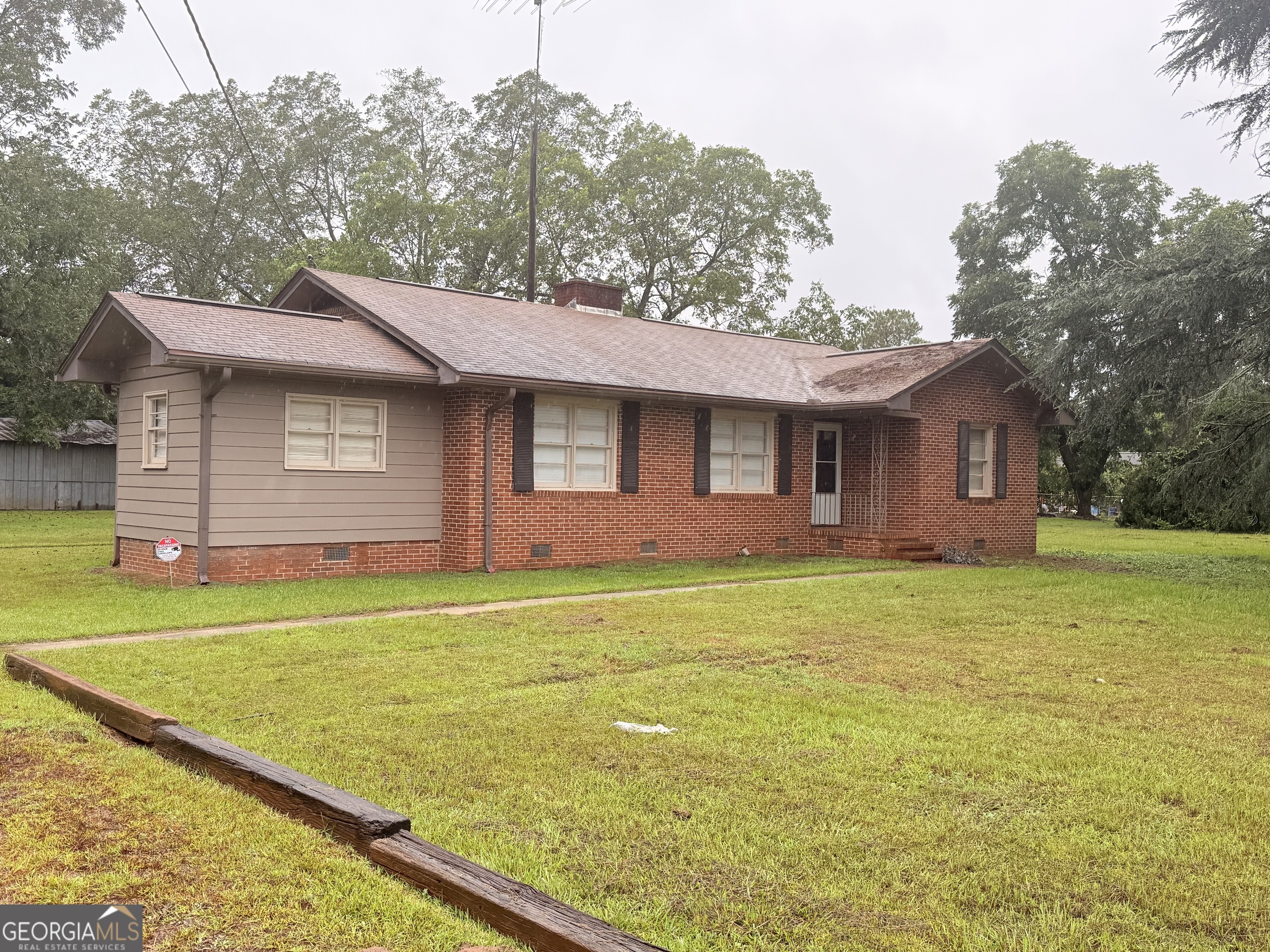 Welcome to this charming all-brick home situated on over 1.4 acres of beautiful, flat land-offering the perfect blend of character and warmth. Inside, you'll find hardwood floors throughout. The room off the kitchen has a closet and can easily be converted into a Master bedroom. The home sits on a spacious and level lot, ideal for gardening, entertaining, or simply enjoying the outdoors. In the backyard, you'll find both a shed and a workshop, providing plenty of space for hobbies and storage. Whether you're seeking peace and privacy or a place to create your dream lifestyle, with a little TLC, this property offers endless possibilities. This is a rare opportunity to own a home with so much charm, space, and potential.