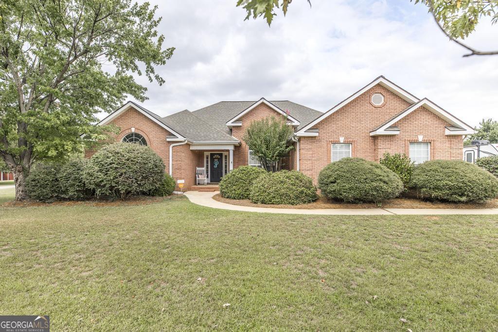 This 4 bedroom 2 bath home is move in ready with Upgrades Galore!  This home sits on almost 1/2 an acre corner lot.  It has hardwood floors, formal dining room, kitchen with granite counter tops, judges paneling, built in pantry, stainless steel appliances, eat- in kitchen area, bar area, all over looking the salt water POOL!    Enjoy your summer days in your screen porch or take a dip in your pool.  Pool decking has been resurfaced.  Large Master Bedroom with hardwood floors, trey ceilings and master en suite has been remodeled with granite countertops, double vanity, jetted tub, custom tiled shower and walk in closet. Extras include: hotwater heater has been replaced, sink in garage storage room, fully decked attic, gutters, Roof approx. 4-5 yrs old, Carpet in bedrooms replaced  (1-2 yrs ago).  Call us today for your personal tour!