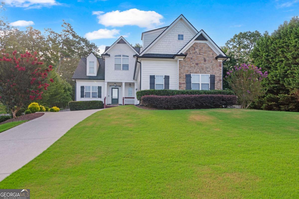 This Rydal residence, situated on a generous .71-acre lot within The Foothills subdivision, offers a compelling blend of design and community amenities. The property's exterior, with its established landscaping, provides a welcoming presence. Residents of this community enjoy access to a swimming pool for summer recreation, interconnected sidewalks for easy neighborhood navigation, and the modern convenience of underground utilities. The main level of the home is laid out for both private moments and social events. The front door opens to a dedicated dining room, a space well-suited for hosting. The kitchen, with its practical pantry, flows into a casual breakfast nook, an ideal spot to begin the day. An open-concept living area, highlighted by a central fireplace, provides a comfortable and inviting atmosphere for relaxation or conversation. A notable feature of the main floor is the primary suite. This private sanctuary is a quiet space for unwinding, complete with an attached bathroom and a large closet for organization. A functional laundry room and a convenient half-bath on this level further enhance the home's daily utility, providing a sensible and efficient floor plan. The second floor is comprised of additional quarters. Two well-sized bedrooms offer comfortable accommodations for occupants or guests. They are served by a full bathroom, centrally located for convenience. This level also features a versatile bonus room. This adaptable area can serve as a media room, a home office, or a recreational space, allowing the home to evolve with the needs of its residents. Outdoor living is a significant aspect of this property. A two-year-old deck extends from the back of the home, providing an expansive area for enjoying the warm Georgia weather. A gazebo, added to the deck, offers a perfect shaded retreat for dining or simply relaxing outdoors. The extensive .71-acre backyard is fully fenced, creating a private and secure space for a variety of outdoor activities. The full unfinished basement represents a key opportunity for future expansion. It is already stubbed for a bathroom, making it a viable blank canvas for new living areas, a gym, or dedicated hobby space. The home is further supported by a two-year-old roof and water heater, providing assurance regarding these essential components. This property presents a balanced and functional living environment, integrating indoor comfort with significant outdoor potential and access to a desirable community. It is an ideal setting for those seeking a home that can adapt to their lifestyle. Please contact our team to arrange a personal tour and learn more about this exceptional property.