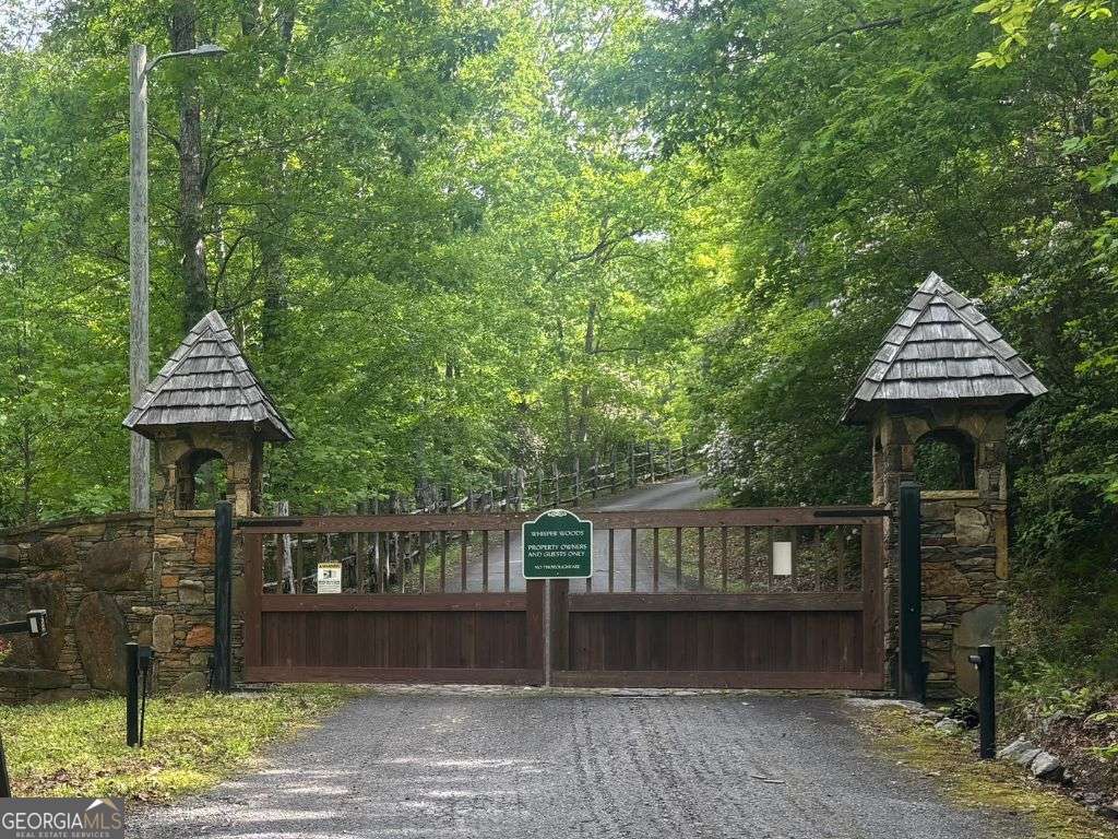 Own a prime 2.12 acre-lot in the prestigious Whisper Woods Estates, perfectly positioned at the end of a tranquil cul-de-sac. This gated community offers unmatched privacy and serene surroundings highlighted by north Georgia's lush flora and native fauna. The lot's topography is ideal for a terrace-level home with underground utilities and public water in place. Selective tree clearing will unveil long-range mountain views, enhancing your living experience. A rare opportunity to create your private mountain retreat in an exclusive location-don't let it slip away!