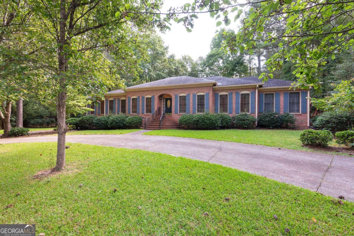 Welcome to this beautiful, 4 sided brick home. Exceptionally built, just needs some updating, great bones to work with! Sold as-is. Circular driveway in front and side driveway to garage in rear of home. Large bedrooms and plenty of space for large families or large gatherings. Huge kitchen overlooking a luscious landscaped backyard and deck.