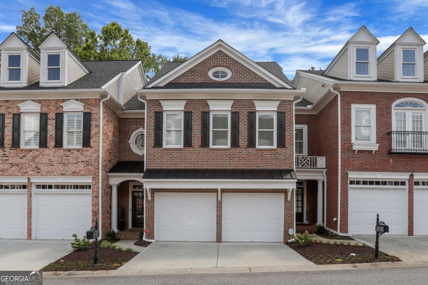Renovated and thoughtfully designed, this Academy Park townhome offers the perfect blend of luxury, function, and a coveted lifestyle just minutes from Avalon and Downtown Alpharetta. Set on one of the community's best lots, the home boasts serene creek views from not one but two outdoor living areas, as well as an impressive terrace level built for entertaining. The main level features a bright family room with a fireplace that flows seamlessly to a new deck with Trex decking, a gas line for grilling or a firepit, and a stunning wooded view. The renovated kitchen is a true centerpiece with a quartzite island with a farm sink and a breakfast bar. The white cabinets are complimented by the stunning vent hood over the gas range, the leathered granite countertops and new backsplash. A dining room (currently used as an office), updated half bath, and a garage with added storage complete the main level. Upstairs, the spacious primary suite includes a cozy sitting area, a walk-in closet, and a luxurious bath with a jetted tub, walk-in shower, and white cabinetry. A second bedroom has an ensuite bath and a walk-in closet. The alcove at the end of the hall, ideal for a home office or guest nook, provides excellent versatility. The finished terrace level is a showstopper, featuring a wide-open living space with a second fireplace, a third full bath, a walk-in closet, and an entertainment bar complete with a beverage refrigerator, a sink, an ice maker, and a marble countertop. Thoughtful additions like dual trash pull-outs and in-cabinet corner storage make it as functional for entertaining as it is beautiful. This space could easily be used as a guest suite, and a wall could be put back up to create a separate bedroom if preferred. A covered porch with a waterproof under decking system and teak flooring offers a second outdoor living area overlooking the creek. Additional highlights include new lighting and updates throughout this stunning home, hardwood flooring added upstairs, and abundant storage. Academy Park is a gated community offering resort-style amenities - a clubhouse, an updated fitness center, a pool, tennis and pickleball courts, an onsite property manager, private trails with creek bridges and a direct exit to the Alpha Loop, Avalon and downtown Alpharetta. This home combines comfort, luxury, and location in one remarkable package.