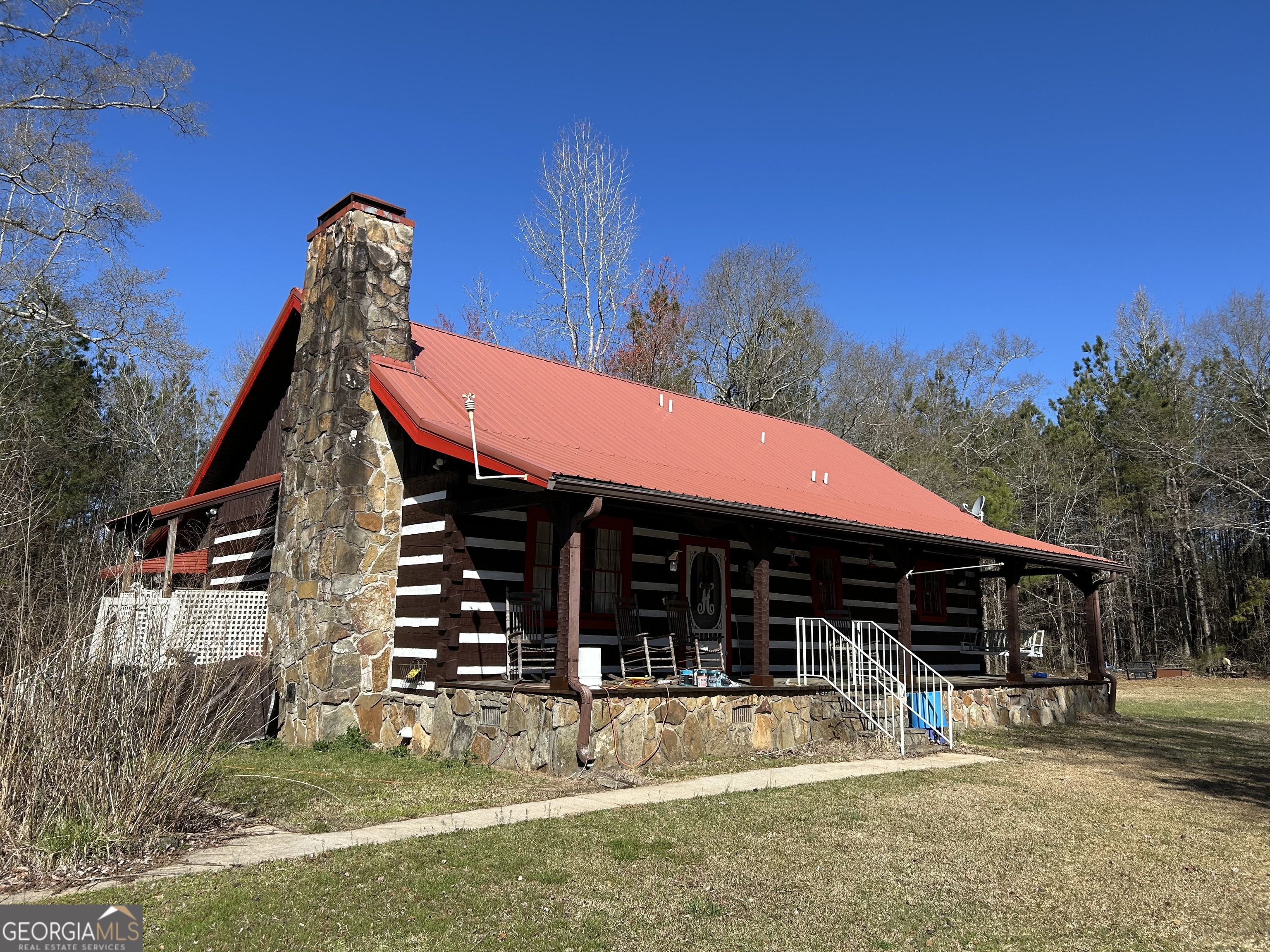 Located just a short drive to Dallas, I-20, Villa Rica and Douglasville, this farm home has country charm with city convenience. Surrounded by pretty pasture land which is partially fenced, wooded acreage for the hunter and bordering Crider Creek and Mud Creek this property checks all of the boxes for a Homesteaders dream! A three bedroom log cabin with a loft adds charm and makes for a perfect residence or for a weekend retreat. Home has hardwood floors and solid surface countertops in the kitchen and has a beautiful stone masonry fireplace. Vaulted ceilings adorn the great room. When summer arrives you can enjoy the beautiful salt water pool just steps away from the cabin. There is also a mobile home on the property which is currently rented, generating income. Property does house a well however the home is currently serviced by county water. 17.1 acres of this property is located in Carroll County. Parcel # 1190042 the remaining acreage 65.06 acres is located in Paulding County. PLEASE ALLOW 24 HOURS NOTICE TO SHOW