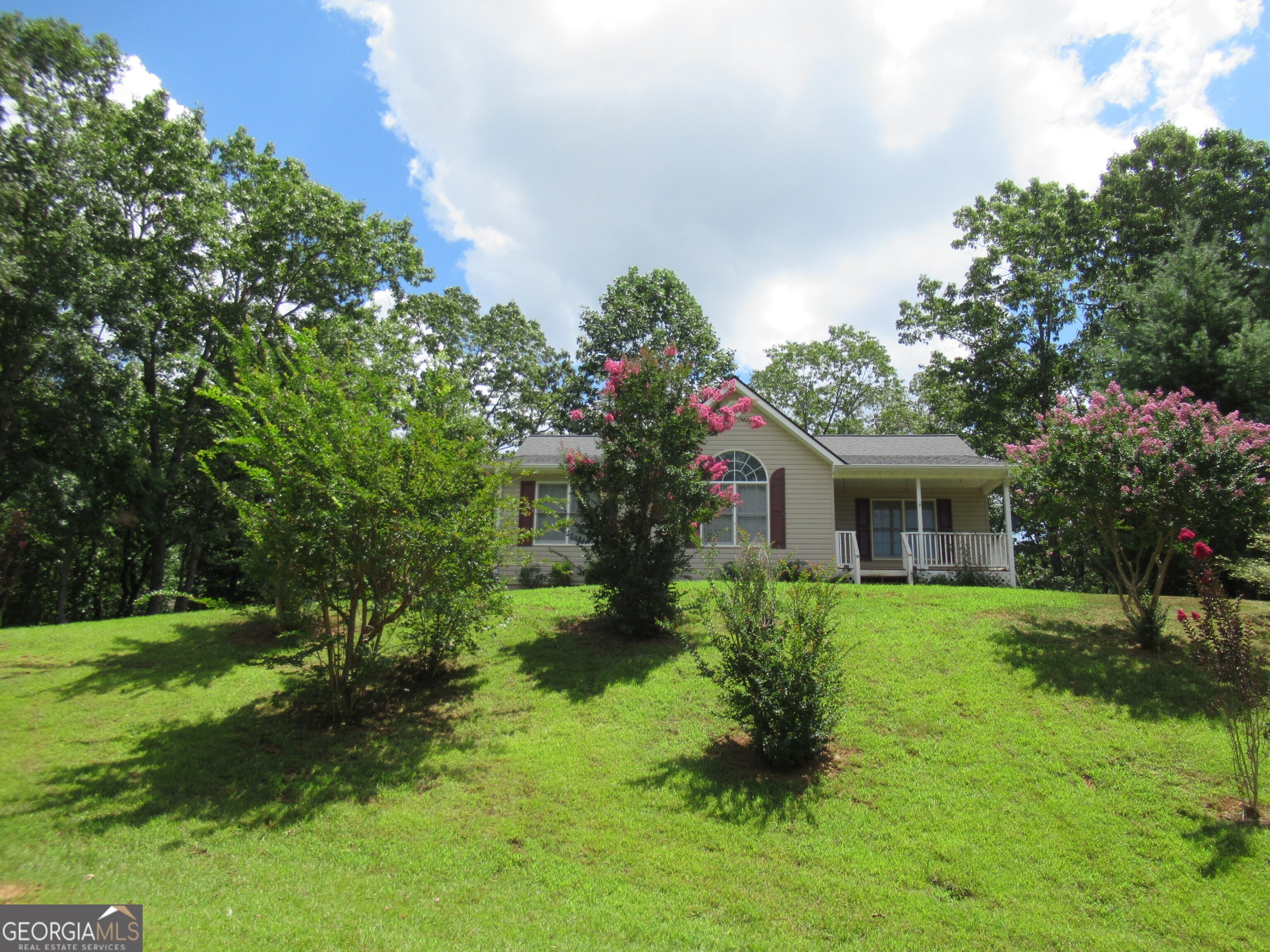 Ranch home with unfinished basement on over 1 acre in Dahlonega close to everything, yet private and peaceful. 3 bedroom and 2 full bath. Open concept main living floor plan. Kitchen with stained cabinets and open view into family room. Primary bedroom and 2 additional bedrooms are on main level. The basement is ready for your unique design & needs. No rental restrictions. Come see today.