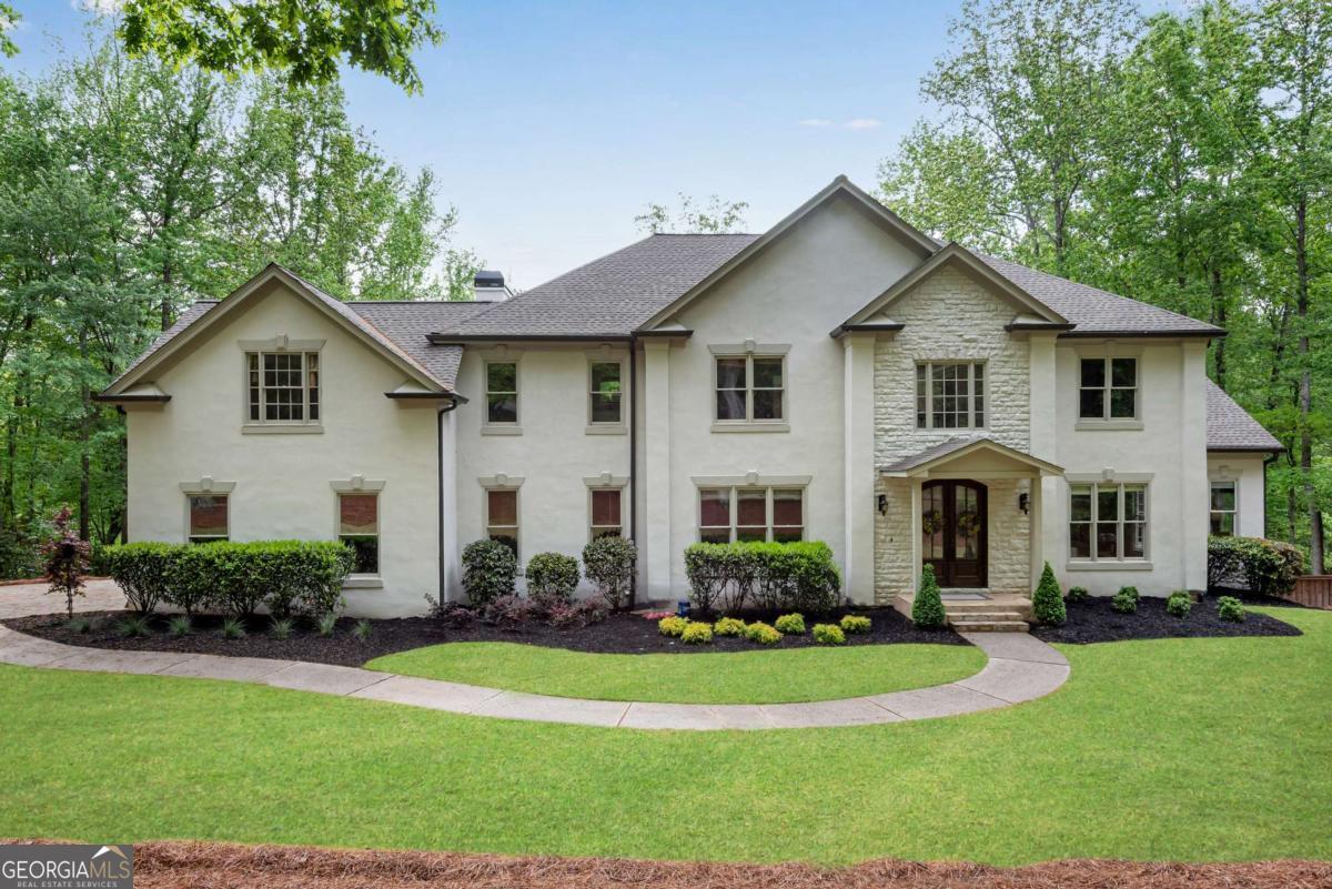 Rare Opportunity to Own a Beautifully Updated Estate Home on Nearly 3 Private Acres with a Saltwater Pool and No HOA-All in One of South Forsyth's Most Desirable Locations! Nestled in an enclave of estate homes just minutes from Peachtree Parkway and located in the top-rated Denmark High School district, this expansive residence offers over 5,000 square feet of living space, featuring 5 bedrooms and 4.5 bathrooms, including two primary suites-one on the main level and one upstairs-ideal for multi-generational living. Completely renovated from top to bottom, this move-in ready home boasts new interior and exterior paint, refinished real hardwood floors, all-new carpet, and new ceiling fans. The kitchen has been tastefully refreshed with quartz countertops, a new gas cooktop, and a new refrigerator. Every bathroom has been stylishly updated, including free-standing tubs, new toilets, features a walk-in showers! Major systems have been replaced for peace of mind, including FOUR brand-new HVAC units, a 30-year architectural shingle roof (approx. 3 years old) with new roof decking, gutters, and trim, a 3-year-old hot water heater, and new decking and railings....basically nothing was left untouched! Step outside to your private backyard oasis featuring a sparkling saltwater pool and fresh new landscaping-perfect for entertaining or unwinding in total serenity. Hot Tub Included! This home offers the perfect blend of privacy and convenience, just minutes from The Collection, top-rated schools, dining, and shopping. Homes like this are rarely available-don't miss your chance to make it yours!