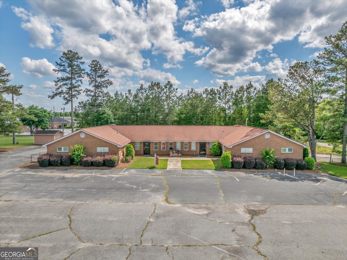 Conveniently located near Dodge County Hospital among dental and medical offices, this pristine property is turnkey. Completely renovated in 2018, this building boasts 8 individual handicapped-accessible suites, each with its own closet, television, and private restroom. Conference room, waiting room, vending room, dining room, chapel, records room, and break room complete this office building that holds designation as a Personal Care Home. Most recently used as a hospice care facility, the property is designated as a personal care home by the State Fire Marshal. It is in excellent condition and sale includes majority of equipment and furnishings. New sprinkler system and back-up gas-powered generator located on site. Currently zoned as P-professional, building is ready for business at closing and has parking in front and rear. Seller will also consider lease. Call/text agent today to set up a showing appointment.
