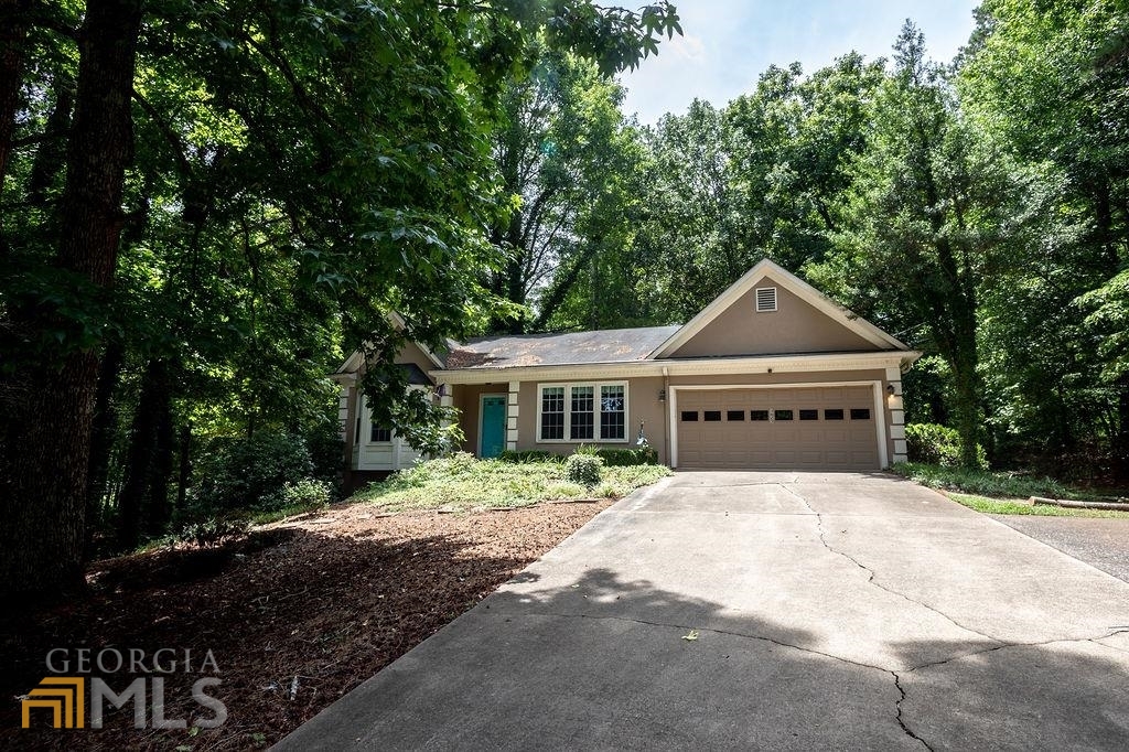 Highly sought after Ranch on an unfinished basement! This wonderful 3 bed 2 bathroom home has been well maintained and is located in the tranquil Hill Top neighborhood. The living room includes a beautiful pitched ceiling with 2 skylights providing plenty of natural light. It also has an entire wall of bookshelves and a gas fireplace making for cozy reading. The kitchen conveniently maintains clean lines of sight into the living room and includes a gas stove, dishwasher, and refrigerator. The formal dinning room has plenty of space for hosting or enjoying a meal. Past the living room, the owners suite includes his and her closets, with easy access to the primary bathroom. On the other side of the home there are 2 additional bedrooms and 1 full bathroom. Both the bedrooms and bathroom provide ample space. Stairs located next to the living room lead to the unfinished basement. The basement has plenty space and is full of potential. There is even a garage door to access the basement located on the side of the house, making moving large furniture or equipment into the basement a breeze. So much to like about his home. Easy access to restaurants and shopping, with a new Publix being built near the neighborhood. Schedule your showing today!