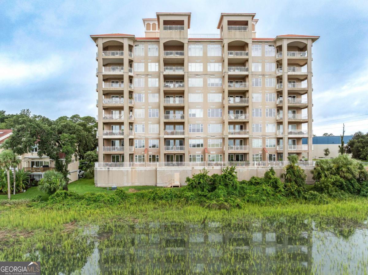 Discover the epitome of luxurious coastal living at Bull River Yacht Club, where elegance and comfort seamlessly blend to create your perfect home. Access this stunning residence via a private elevator that opens directly into the unit, an interior filled with sophisticated details and modern updates. Step out onto the extra-large balcony to enjoy your morning coffee while soaking in the breathtaking sunrise over the tranquil Bull River. The spacious, open concept living area is illuminated by ample natural light. It features exquisite tray ceilings that enhance the sense of grandeur, complemented by stylish pocket doors that lead to a versatile office-ideal for remote work, reading, or quiet reflection. The primary suite is a true retreat, offering two generous walk-in closets, dual sinks, a luxurious, spacious shower, and a separate tub, providing the ultimate in comfort and privacy. As the day winds down, unwind at the rooftop pool where you can enjoy sweeping panoramic views of the surrounding waterways. Evenings are made magical with stunning sunsets, creating a perfect backdrop for gatherings or peaceful moments of relaxation in this beautifully updated, light-filled coastal sanctuary.