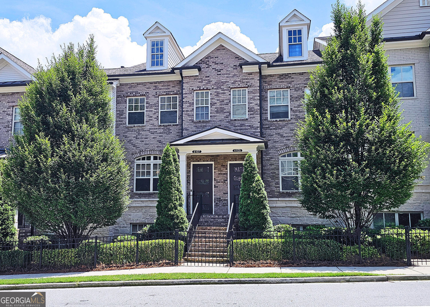 This incredible luxurious three level newer construction is in the coveted GATED "The Townes at Chastain" community in the city of Sandy Springs. You'll enjoy luxurious and low maintenance living. This home has quality design and finishes, plus a lifestyle great for entertaining. The spacious 2 bedroom/2 bath/2 1/2 baths townhouse screams designer. You'll enjoy a blend of luxury, comfort, and convenience with an ambiance which is inviting and sophisticated. LOCATION, LOCATION, LOCATION. You're in an ideal location with everything at your fingertips and moments from treasured Chastain Park & Amphitheater, great shopping, casual and fine dining, and entertainment. The exteriors are elegant with brick and cement siding. You'll enjoy a luxurious interior with over $40,000 in Builder upgrades, low maintenance, and an energy efficient lifestyle. A few energy efficient features: appliances, gas hot water heater, HVAC, thermostat, fully insulated walls, ceiling & attic, dual pane windows. You're "WOWED" upon entering with open concept living, bathed in abundant natural light, soaring 10" ceilings, upgraded decorator lighting, recessed lighting throughout, and beautiful upgraded wood floors throughout, (carpet in 2nd bedroom). There's an impressive front entrance to the building with gate, porch and welcoming foyer. Take foyer to a lovely formal dining room with great windows, chandelier, and upgraded brick wall. The dreamy chef's kitchen, is the heart of the home, has abundant white custom cabinets all the way to the ceiling, and under cabinet lighting, Countertops are beautiful, chiseled edge granite, ceramic tile backsplash, stainless energy efficient appliances, large island, breakfast bar, and pantry. Spacious family room has floating shelving, an upgraded brick wall, and a cozy modern electric fireplace with flame and mood lighting settings. Everyone will enjoy the relaxing deck off the family room. The main floor powder room has lovely upgrades with two decorative glass tile walls, wood cabinetry, and oversized sink. Upper level has two en-suites with a desirable roommate floor plan. Both bedrooms have upgraded 10' tray ceilings. The stately master en-suite has great windows, huge closet, and spa-like master bath with upgraded vaulted ceiling, dual vanities, wood cabinetry, and huge walk-in frameless glass shower with dual showerheads. The secondary bedroom en-suite with 10' tray ceiling has a large walk-in closet, and private tile bath. Laundry closet is conveniently located upstairs-washer/dryer remain. You'll love the additional space on the terrace level with a wonderful bonus room/flex space, powder room, and one car garage with custom epoxy flooring. A security system is in place. "The Townes at Chastain" is a walkable lifestyle community with a sparkling community pool, outdoor grill area, and peaceful seating areas in the community. In 2019, the subdivision was named "Community of the Year" by the GA Home Builders Association. THIS TOWNHOUSE HAS IT ALL!