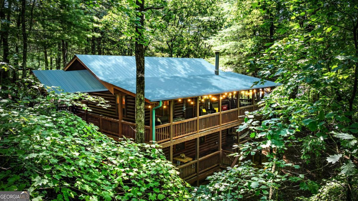 Amazing deal! Looking for a quick close. Don't miss out on this opportunity. This is a true log mountain getaway! Enjoy the Cherry Lake community offering community lake access. You can also walk the Benton McKaye trail which meanders thru the development. This is minutes away to downtown Blue Ridge! This sweet 2 BR, 1 BA cabin offers a 2+ car carport, a back up generator and a hot tub. The 2 bonus rooms downstairs could be used as a third bedroom, studio, craft room, workshop, extra living room, or game room - the choice is yours! This cabin offers a wood burning fireplace, oversized decks w/grilling porch, end of the road privacy and it is the perfect vacation home, second home or rental property. Come see for yourself!