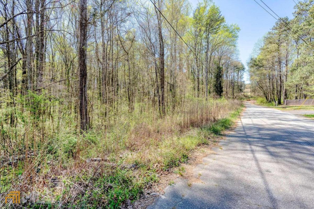 9.5 Total Residential Acres in Marietta Ga, this sale includes 4 lots that total 9.5 acres, lots included are parcel number 19070300580 with 7.1 acres, 959 Old Milford Church Road Parcel number 19070300310 with 1.1 acres, 929 Old Milford church road parcel number 19070300450 with .50 acres, and 969 Old Milford Church Road parcel number 19070300440 with .80 acres. Property is near the corner of Hicks Road, Smyrna Powder Springs Road and Milford Church Road, across from Milford Baptist Church and walking distance to Birney Elementary School. Electrical Power, Cobb County water service, and Natural Gas from Austell Gas, on site at 959 Old Milford Church and 969 Old Milford church, the 7.12 parcel has a sewer easement on the property. Only 6.9 miles to I-75 and 8 miles to the Braves stadium and The Battery. Two homes and a barn on the property which could be renovated or torn down. Property is heavily covered with ready to harvest hardwoods and has a creek running through the property in two locations.