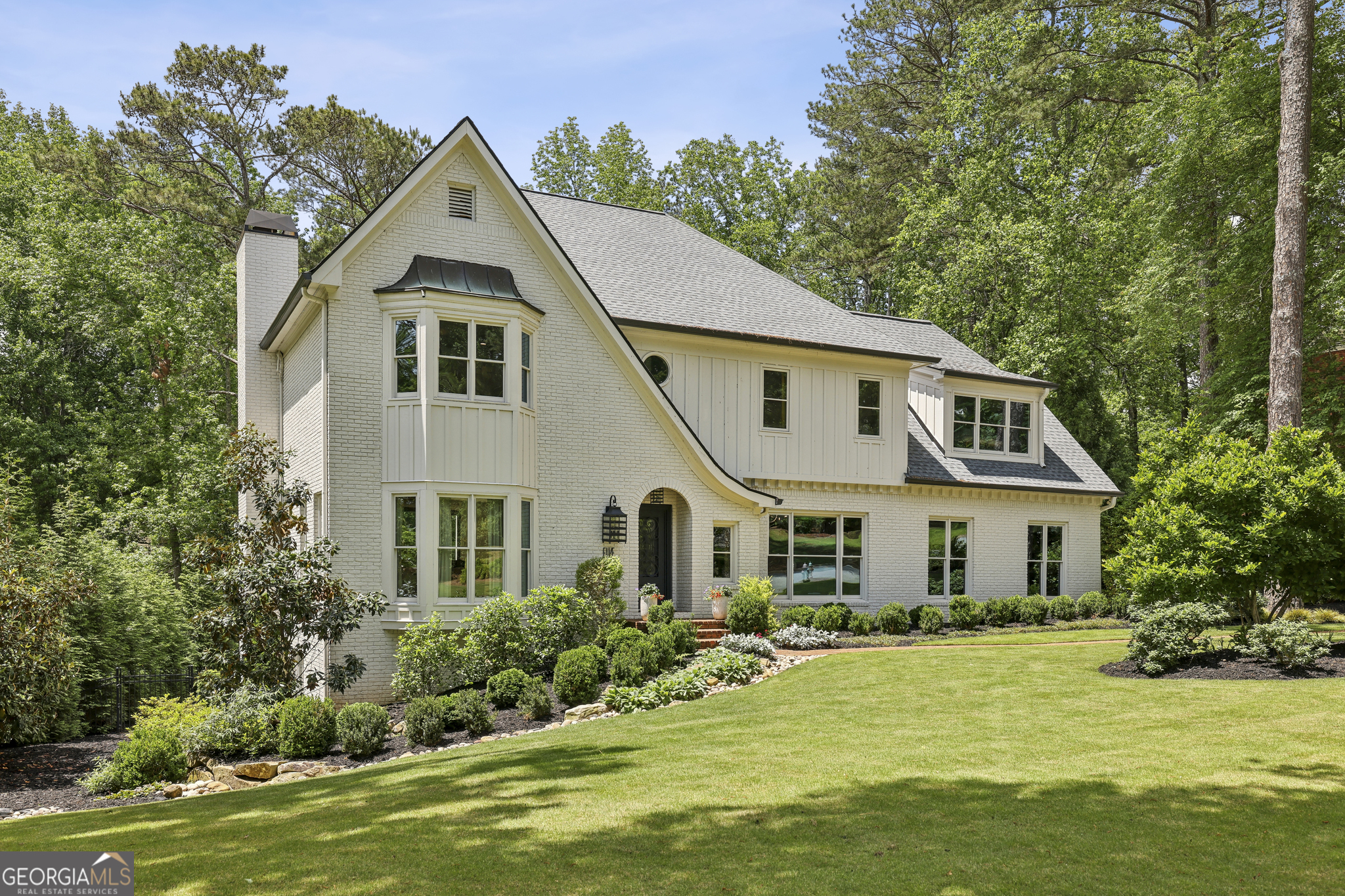 Experience the pinnacle of lakefront and poolside living in Windward with this beautifully reimagined five-bedroom, four-and-a-half-bath residence, ideally located just minutes from Avalon and the vibrant energy of downtown Alpharetta. Fully renovated with an eye for both elegance and comfort, this home masterfully blends sophisticated modern finishes with inviting, livable design. In 2021, the homeowner undertook a transformative renovationCoopening walls, reconfiguring rooms, and reimagining the rear of the home to invite in more natural light and forge a seamless connection to the outdoors. Every window was replaced, and new sliding glass doors were added to enhance lake views and indoor-outdoor flow. A newly added staircase from the deck to the backyard provides easy access to the lake, pool, and lush green space, making outdoor living effortless. Inside, no detail was overlooked: from wide-plank designer flooring and curated high-end fixtures to custom doors, premium surfaces, and appliances, the home exudes quality throughout. The open-concept layout offers a private office, two dining areas, and a spacious great room framed by walls of windows that capture stunning views of the lake and pool. The gourmet kitchen is both stylish and functional, featuring a casual dining area and direct access to a full-length deckCoperfect for entertaining or enjoying a quiet morning coffee overlooking the water. DonCOt miss the hidden door leading to the walk-in scullery, or the custom dog washCoideal for any pampered pup. Upstairs, via either the front or back staircases, youCOll find four bedrooms, including a serene primary suite with a full wall of windows and captivating views. The spa-inspired primary bathroom boasts a Japanese soaking tub, dual vanities, and a spacious walk-in closet. Three additional bedrooms and two full baths complete the upper level. The fully finished terrace level elevates the homeCOs entertainment capabilities, offering a custom bar, a gym, a flexible office or media room, a guest bedroom, and a full bath. Step outside to your own resort-style retreat, featuring a sparkling pool, spa, outdoor kitchen, and a covered lounge areaCoall thoughtfully designed to harmonize with the tranquil lakefront setting. A private dock and pontoon boat extend the experience, inviting endless days on the water. Whether you're hosting a lively gathering or enjoying a peaceful sunset, this home is the perfect blend of indoor luxury and outdoor serenity. Situated in AlpharettaCOs sought-after Windward community, residents enjoy access to a private 195-acre lake, as well as neighborhood amenities including a playground, dog park, community garden, and boat launch.