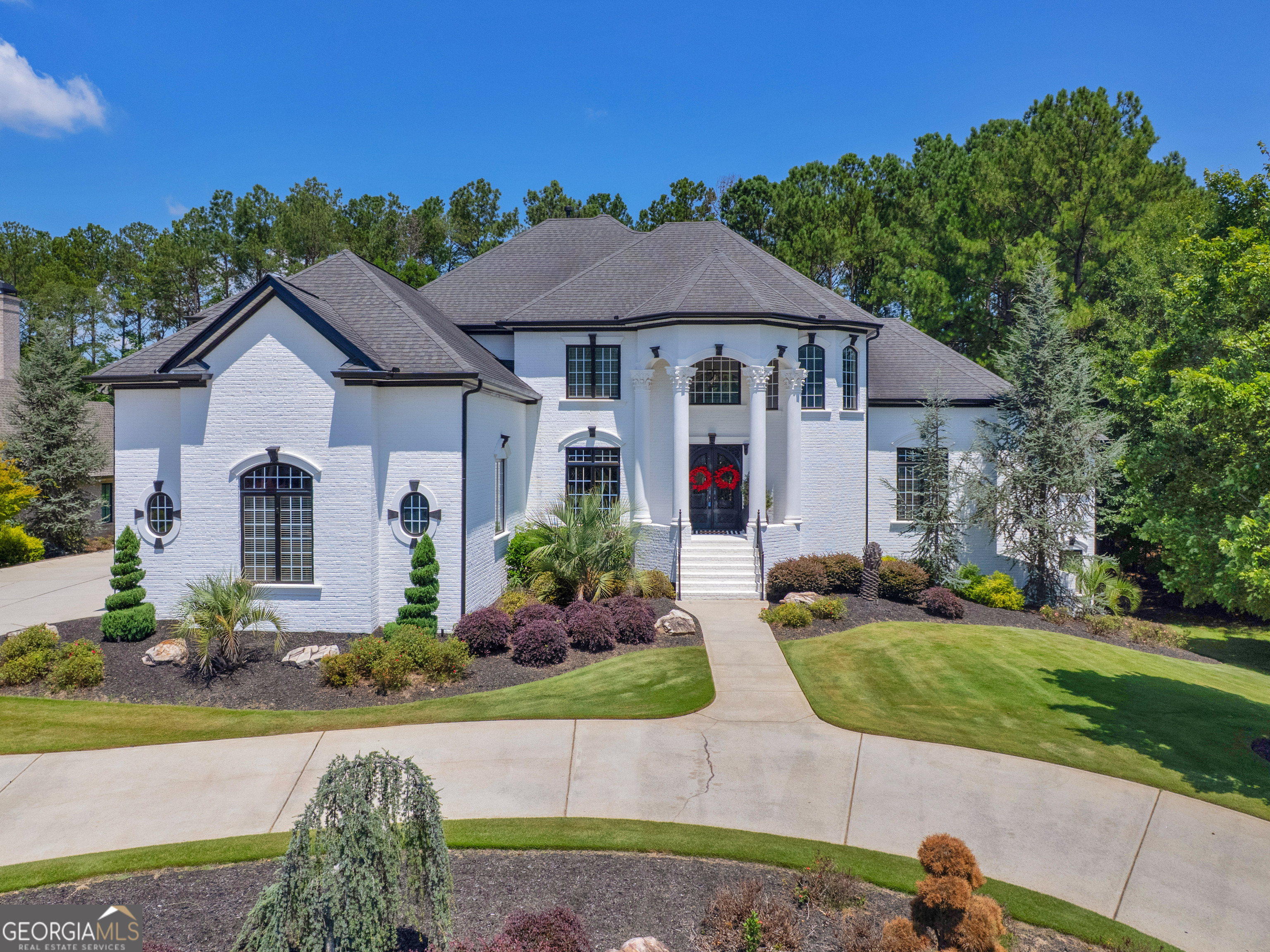 Welcome to 1002 Legacy Hills, an exquisite estate nestled in the prestigious, gated community of Eagles Landing Country Club in McDonough. This stunning 6-bedroom, 5.5-bath residence blends timeless elegance with modern luxury, offering an exceptional lifestyle both inside and out. The expansive layout features a finished terrace level complete with a spacious recreation room, a cozy family room with fireplace, wet bar area, 2 bedrooms, 2 full baths, and a private exercise room. With the main level offering a formal dining room, formal living room, and spacious family room, you will have plenty of room to host gatherings with family and friends. The gourmet chef's kitchen features double ovens, built-in microwave, warming drawer, 6 burner gas cooktop, trash compactor, a large island with seating, walk-in pantry, and butler's pantry with built-in wine cooler. The main-level owner's suite is a true retreat, boasting its own fireplace, a morning bar with sink, a spa-inspired bath with a large steam shower, soaker tub, and a custom walk-in closet with built-ins. Step outside to your own private oasis. This resort-style backyard features a sparkling pool with integrated hot tub, a built-in fireplace feature, lush landscaping, and ample patio space ideal for entertaining guests or enjoying peaceful evenings under the stars. With refined architectural details, soaring ceilings, and access to championship golf, tennis, and premier amenities, this home embodies elevated living in one of McDonough's most sought-after communities. Don't wait to make this well-maintained home yours. Schedule your showing today! Ask how you can receive up to $1500 credit by using one of our preferred lenders. Exclusions may apply.