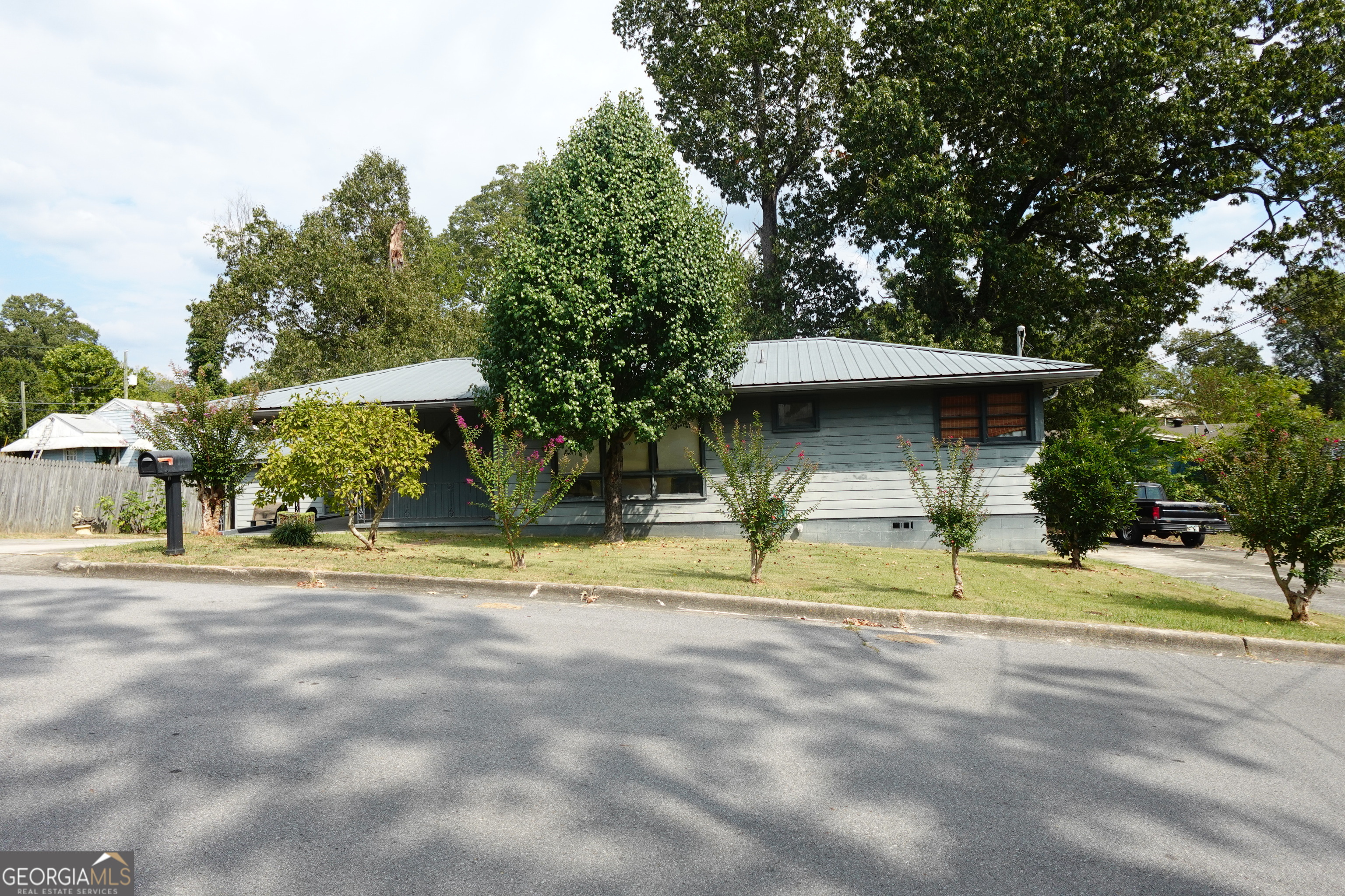 Charming 3BR/1.5BA ranch in West Rome, just off Shorter Ave. Natural light fills the living room through a large picture window, leading to an eat-in kitchen with side entry to the carport and separate laundry room. One bedroom can double as a den/office with access to the back deck. The hall bath offers a spacious vanity, tub/shower combo, and linen closet. Primary suite includes a private half bath. Fenced backyard with storage shed and deck, plus two driveways for ample parking. Convenient location near shopping, schools, and restaurants.