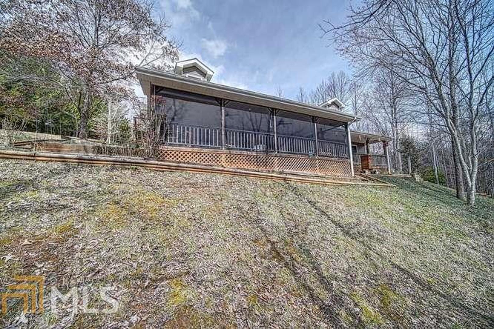 This custom low maintenance home has about everything you could ask for. Large, fast flowing creek frontage, a gazebo by the pond, large enclosed metal garage, RV carport. Pull into the basement garage, walk into the large open kitchen and living room that has cathedral ceilings with a good mix of wood, sheetrock and a rocked fireplace also automatic remote controlled sky lights (new). Kitchen has all new appliances with a huge island and granite. All new hardwood flooring on main as well as most of the upstairs. Laundry and master are on the main, so it's very convenient. New HVAC in 2018. A half bath for guests on the main. Upstairs has 2 very nice bedrooms and a full bath. Nice size loft. Sauna in large open bedroom upstairs. The 2nd bedroom upstairs has a private entrance, perfect for extended family or maybe to rent out for added income. This feels like a cabin on the inside without all the maintenance on the outside!
