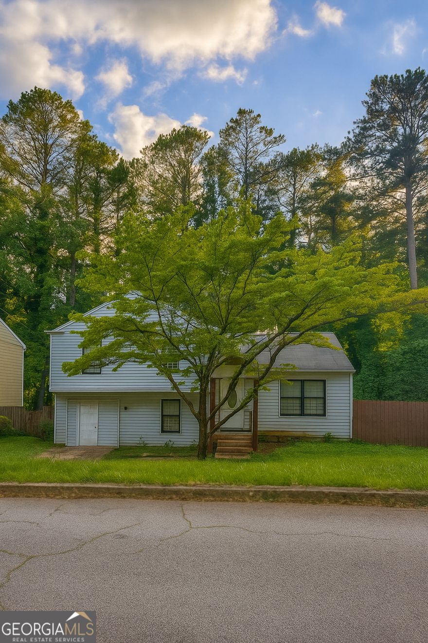 Welcome home to a 3 bedroom 2 bath split level home in the Stone Mountain. Main floor features an open floor plan of living and dining combo. Kitchen features wood cabinets and granite countertops and stainless steel appliances. Step out to a private patio/deck to enjoy your private fenced back yard.  Second level features 3 bedrooms and 2 bathrooms. Lower level features a  cozy family room with a fireplace. Corner lot with neighbors only on one side.