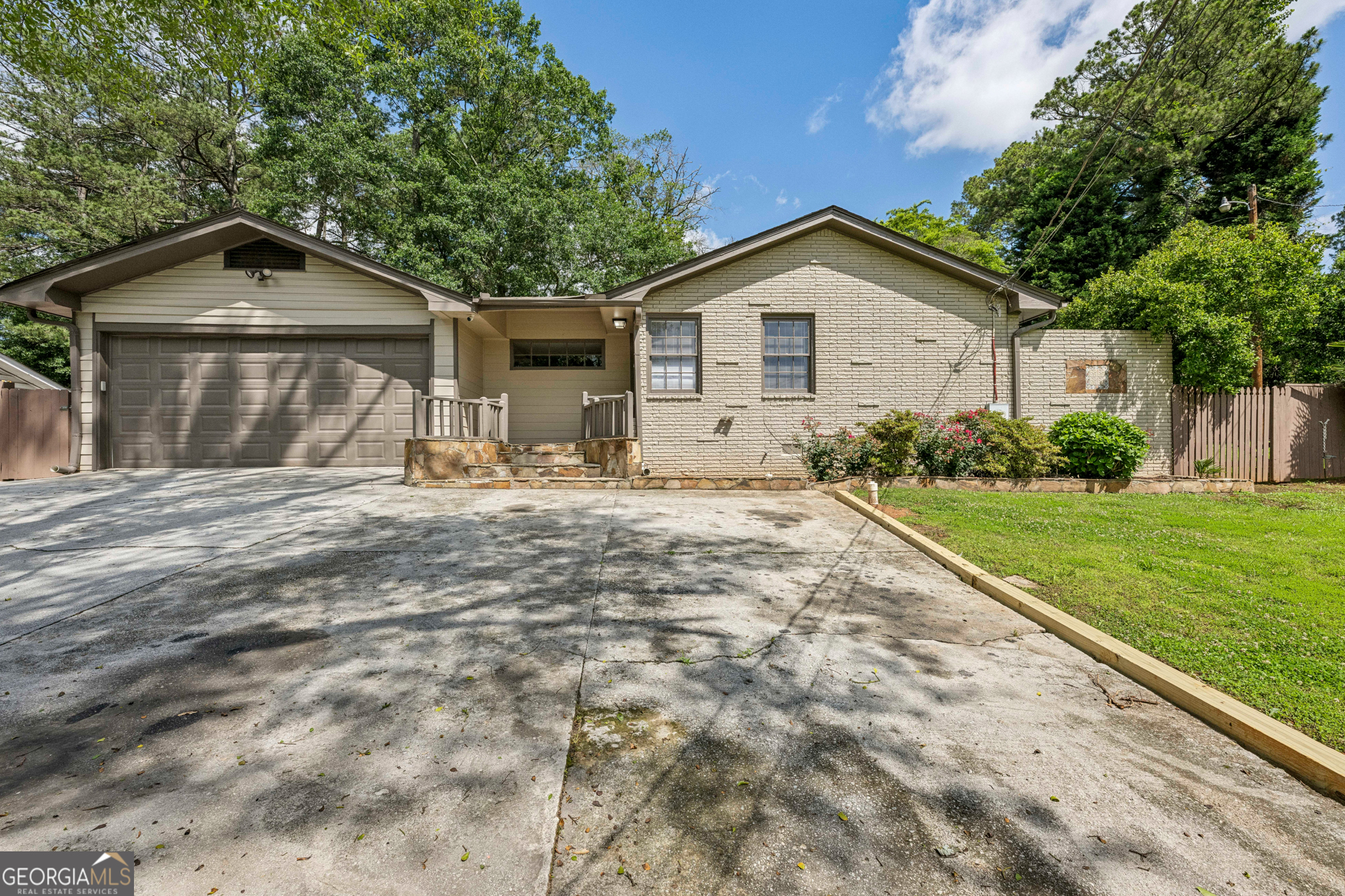 This charming renovated home in Chamblee is a great find! This home has loads of curb appeal with a 4-sided painted brick exterior, nice landscaping and an inviting rear deck. When you enter the home you are greeted by a large open floor-plan with high ceilings and large windows overlooking the deck and private fenced yard. Carpet free with hardwood, laminate and tile throughout and fresh interior paint. Four bedrooms with a potential small fifth bedroom or office. 3 Full Baths and a large separate laundry room with additional storage. Enjoy the warm summer days from your deck and large fenced-in backyard. Two car garage with parking pad for 2 additional cars. Close to the city with easy access to I-85 and I-285. Don't miss out on this opportunity! No pets, please.