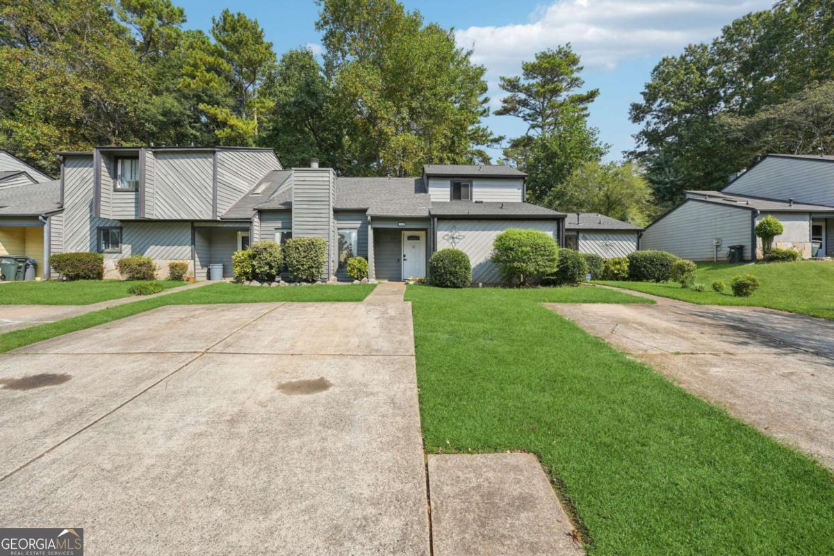Just minutes from Marietta Square, this established townhome community offers the perfect blend of convenience and comfort. You'll be close to shopping, restaurants, and highways, plus only a short stroll or bike ride to Tumlin Park. Inside, the spacious layout features an oversized living room anchored by a beautiful masonry fireplace. Both bedrooms are located upstairs, giving each plenty of privacy. The home also provides generous closet space and an additional storage closet for extra functionality. Step out back to enjoy a comfortable deck overlooking a yard that's ideal for gardening or relaxing outdoors. The design works well for nearly any living situation, whether for roommates, a family, or an individual looking for a flexible setup. No rental restrictions, voluntary HOA, and a prime location near Historic Marietta make this a fantastic value.