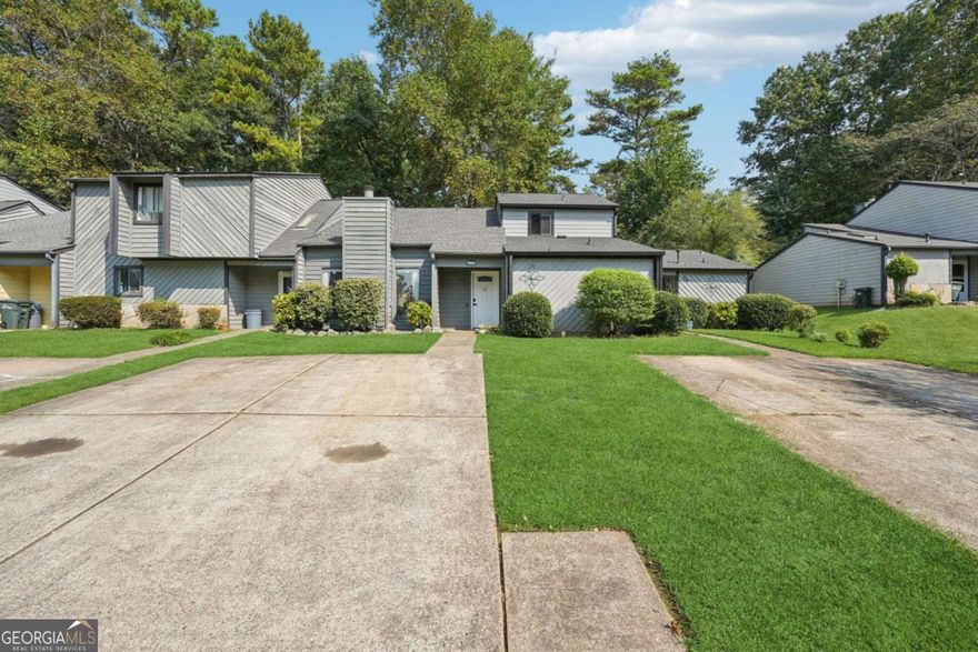 Just minutes from Marietta Square, this established townhome community offers the perfect blend of convenience and comfort. You'll be close to shopping, restaurants, and highways, plus only a short stroll or bike ride to Tumlin Park.    Inside, the spacious layout features an oversized living room anchored by a beautiful masonry fireplace. Both bedrooms are located upstairs, giving each plenty of privacy. The home also provides generous closet space and an additional storage closet for extra functionality.    Step out back to enjoy a comfortable deck overlooking a yard that's ideal for gardening or relaxing outdoors. The design works well for nearly any living situation, whether for roommates, a family, or an individual looking for a flexible setup.     Roof was replaced in 2023, HVAC was installed in July 2025 with 10 year transferable warranty.  No rental restrictions, voluntary HOA, and a prime location near Historic Marietta make this a fantastic value.