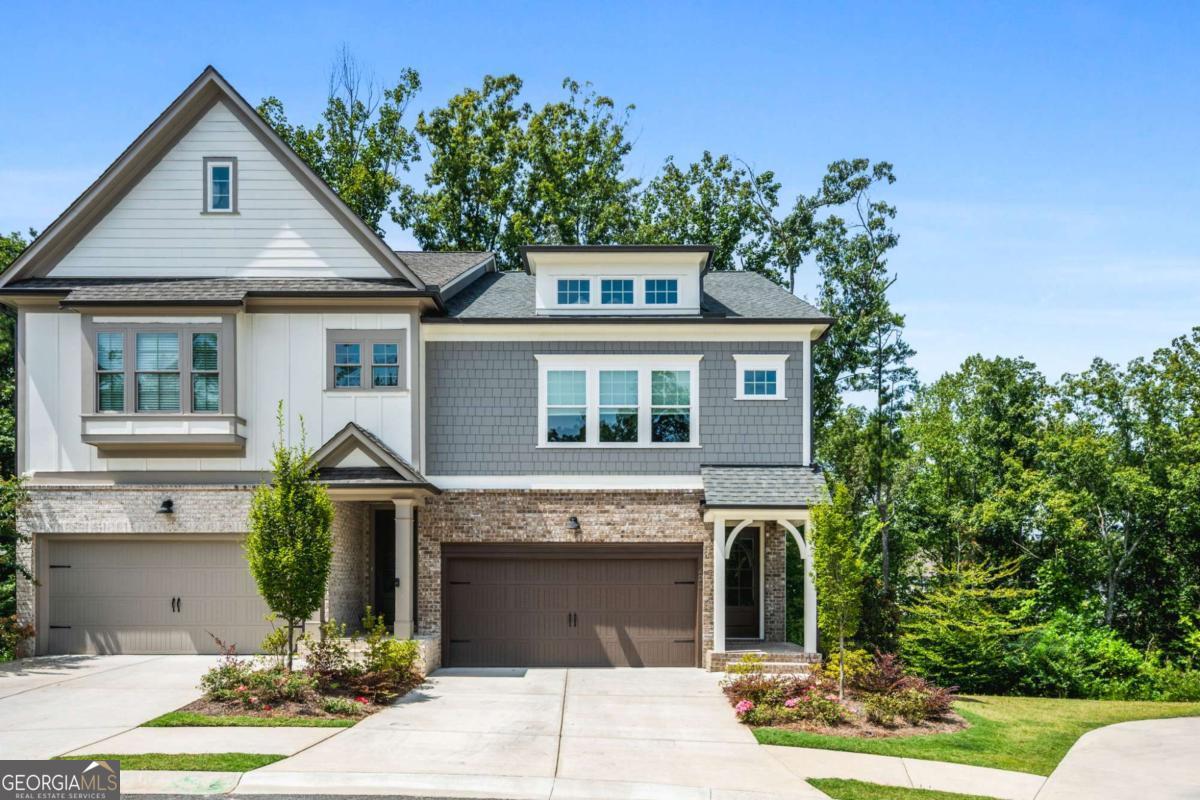 Welcome to this stunning 3-bedroom, 3.5-bath end-unit townhome located in The Retreat at River Green - a beautifully master-planned community ideally situated between downtown Woodstock and downtown Canton, and just minutes from Lake Allatoona. Nestled on a quiet cul-de-sac with no through traffic, this 2-year-old home has been exceptionally maintained by its original owners and thoughtfully enhanced with a number of luxurious upgrades. The main level features an open-concept layout that seamlessly connects the gourmet kitchen, dining area, and spacious living room - perfect for entertaining. Step outside to a custom screened-in porch, offering a peaceful and private outdoor retreat. Throughout the home, you'll find wide plank flooring and designer lighting, adding warmth and elegance to every space. Upstairs, the oversized primary suite includes a private sitting area, a spa-inspired bathroom with a large soaking tub, lighted mirrors, and a separate shower, as well as a fully customized walk-in closet with built-in shelving. The laundry room has been completely reimagined with granite countertops, a deep sink, and ample cabinetry for both function and style. The finished terrace level offers a full additional living space, complete with a large den, full bath, wet bar, and a private bedroom - ideal for guests, in-laws. Don't miss your opportunity to snag this beautifully upgraded, turnkey townhome - homes like this don't last long!