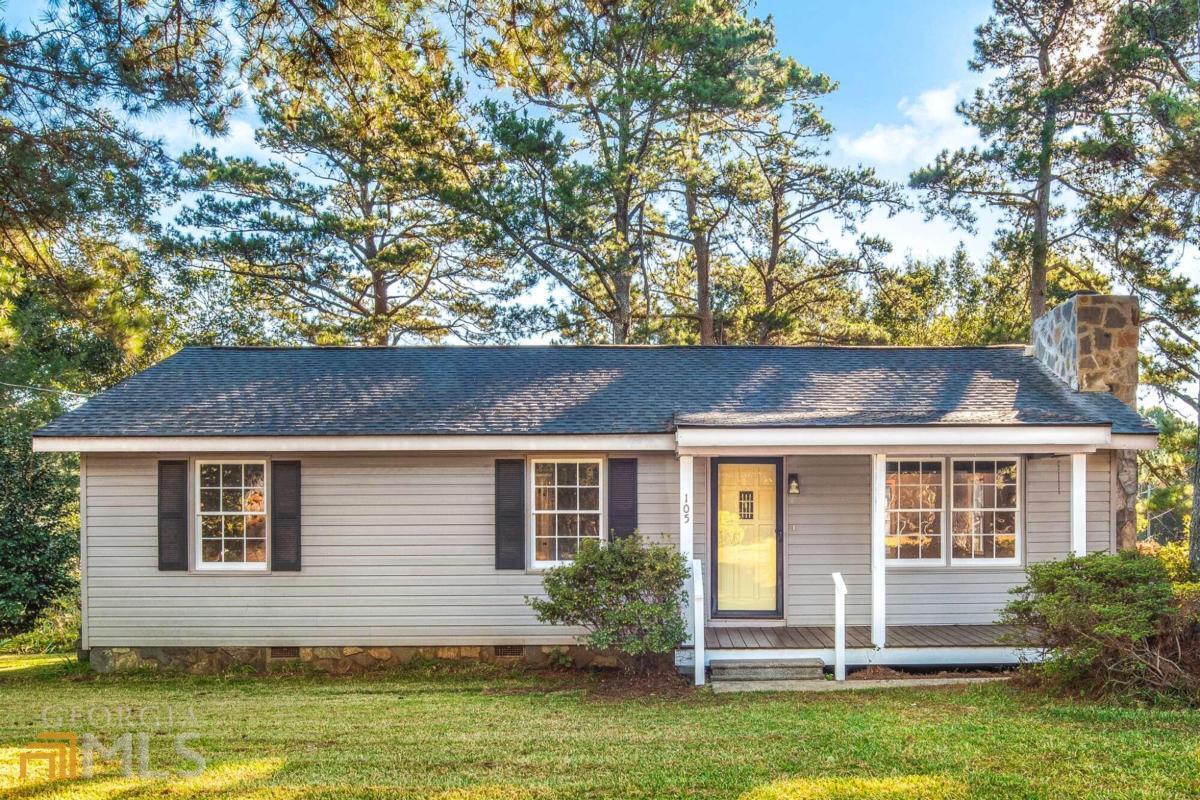 RUN DON'T WALK! This adorable 3 bedroom home features a large sunroom off the back. Family room features stone fireplace. NEW LVP flooring throughout entire home. Freshly painted interior. Kitchen features NEW stainless steel microwave, oven/stove combo, and dishwasher. NEW butcher block countertops, NEW sink and faucet. Features 1.5 bathrooms. BOTH baths have been remodeled. NEW tile shower, NEW vanity, NEW toilets. NEW architectural shingle roof, NEW HVAC. NEW freshly stained porch on the front. TWO outbuildings. All on a 1 acre fenced in lot. Lots of vegetation including pear and fig trees, hydrangeas and St. Augustine grass.