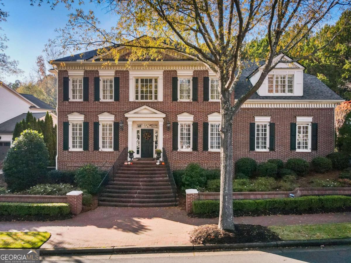 Welcome Home to the Timeless Neighborhood of Ellard where Southern Charm Abounds! This 4-Sided Brick Home with the Owner's Suite on the Main Level is Sure to Please. Hardwoods throughout, Loaded with Trim, Built-In Bookcases, High End Stainless Steel Appliances, Finished Basement and a Very Private Backyard with a 3-Car Garage. Feel the Warmth of 3 Fireplaces in the Family Room, Keeping Room, Basement and a Fire Pit in the Backyard. The Home has Coffered Ceilings, Vaulted Ceilings & Trey Ceilings with Lots of Attention to Detail. Plenty of Space for the Whole Family and Guests with 4 En Suite Bedrooms Upstairs and 1 in the Basement. Enjoy Cooking in your Gourmet Kitchen with a Comfy Keeping Room and Breakfast Bar and Breakfast Room Right there. A Great Entertaining Home! The Private Backyard which Backs up to the Nature Preserve Abounds with Gorgeous Blossoms in the Spring and Summer Making this a Perfect, Relaxing Backyard. The Community has Amenities such as a Conservatory, Tennis Courts, a Swimming Pool, Basketball Court, Playground, Fitness Center, Parks, Walking Trails along the Community and the Chattahoochee River. The Community is Very Active with Social Events Throughout the Year, it has 24/7 Guard-Gated Access and Tree-Lined Brick Sidewalks. Ellard is Walkable to Restaurants, Retail and just a Short Drive to Top-Rated Area Public and Private Schools in addition to Being Minutes from Downtown Roswell, Alpharetta, Peachtree Corners and the Atlanta Athletic Club. You Don't Want to Miss this Opportunity to Live in Ellard!