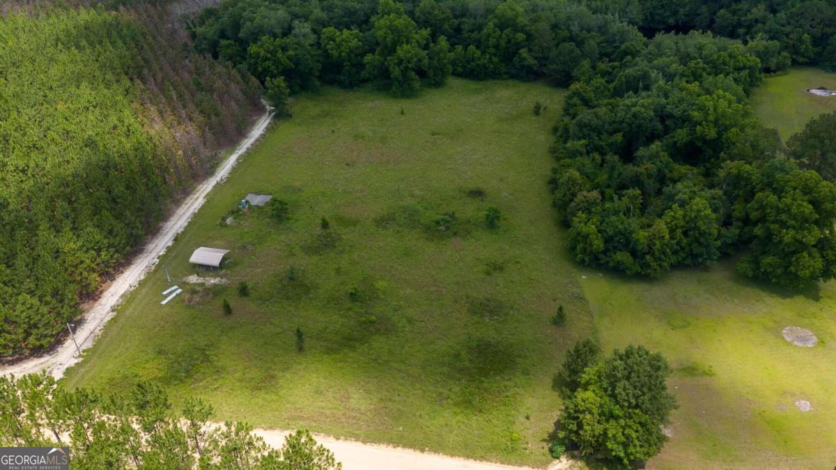 Welcome to the Country! Build your dream home, or bring your mobile home, RV or camper. 5.12 acres, no HOA. The property already has power, 780 ft deep well and septic tank. There is a cement slab and carport for you to park under. The land is already cleared with some woods located on the back of the property. Quiet country living at its finest!