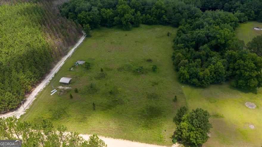 Welcome to the Country!  Build your dream home, or bring your mobile home, RV or camper. 5.12 acres, no HOA.  The property already has power, 780 ft deep well and septic tank.  There is a cement slab and carport for you to park under.  The land is already cleared with some woods located on the back of the property.  Quiet country living at its finest!