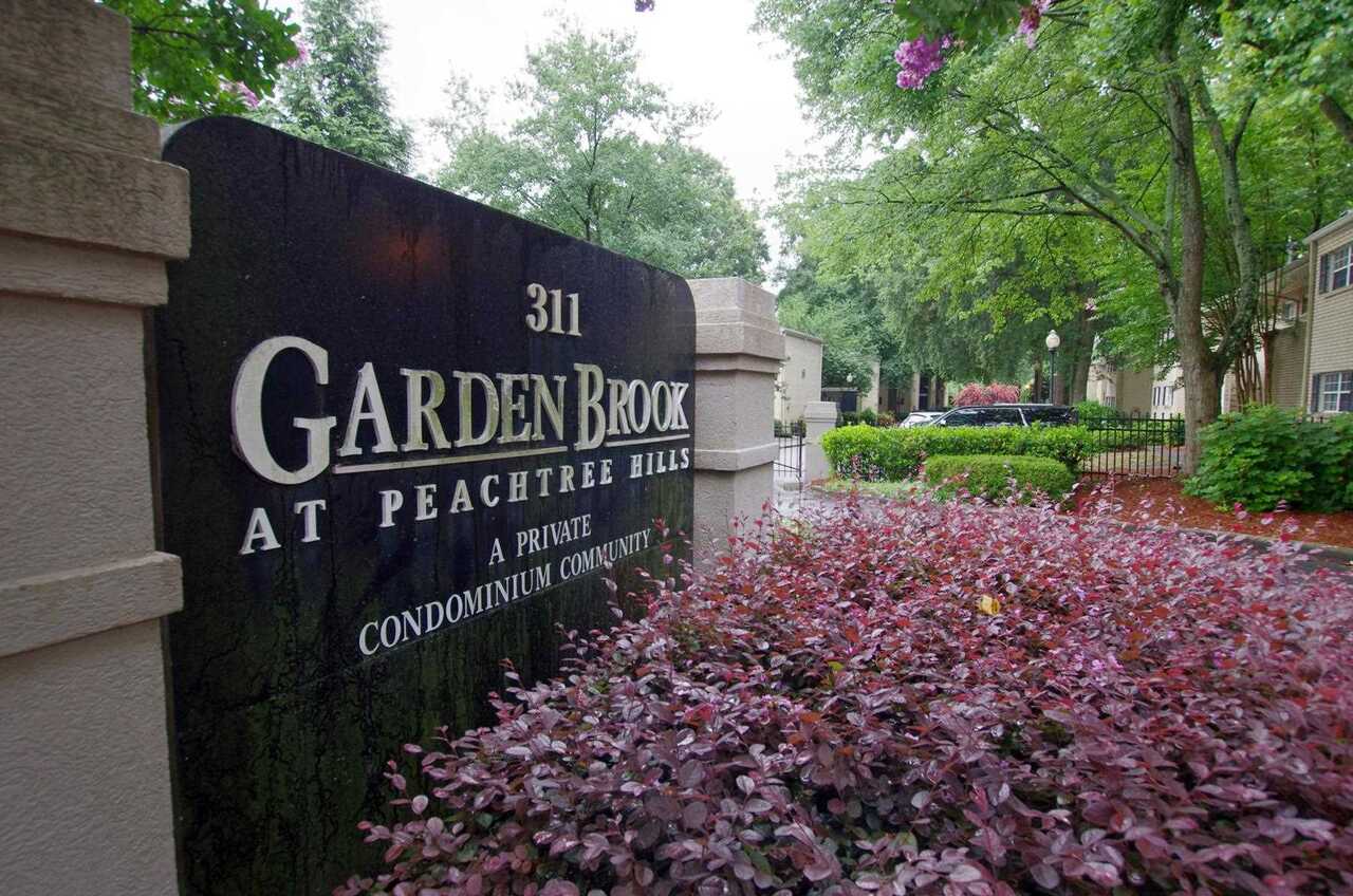 Hidden gem in Peachtree Hills Buckhead. Quiet community with gated access. This 2 BR 1 BA end unit condo is perfect for intown living. Sit on the private balcony overlooking the woods and relax. Hardwood flooring throughout most of the condo and new interior paint. Spacious kitchen with custom features has ample counter space with new refrigerator and new dishwasher. Laundry closet in hallway Exterior entry new paint. Pulldown attic stairs were added to access attic and provide tons of storage space. Prime location, walk to KR Steakbar, Lindberg MARTA and convenient to Peachtree Rd.