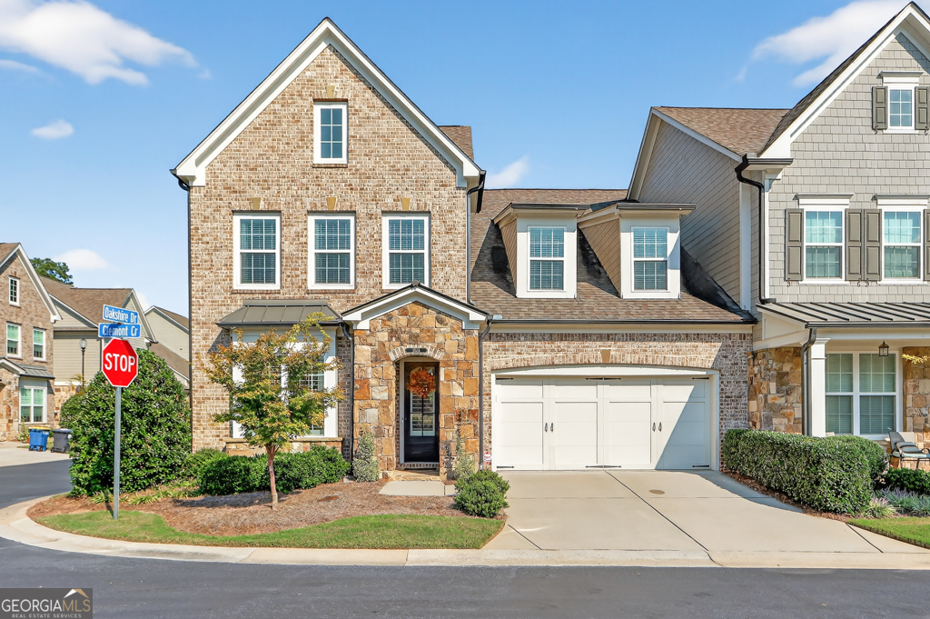 Nestled inside the gated 55+ community of Edenton, this 3-bedroom, 3.5-bath townhome offers a graceful blend of charm and comfort. From the moment you step inside, you're welcomed by a bright front room with custom built-ins, an inviting space that can serve as a home office, library, or simply a quiet spot to unwind. The heart of the home is the family room, where wood beams highlight the soaring ceiling and a striking stone fireplace brings warmth and character. Hardwood floors connect each space, leading into the kitchen where stone countertops, stainless steel appliances, and a large island make cooking and gathering effortless. The cheerful eat-in area is filled with light, perfect for everyday meals or weekend brunch. Upstairs, the primary suite is a retreat of its own. The spa-like bath offers dual vanities, a soaking tub, and a walk-in shower, while the built-in closet organization keeps everything neatly in place. Just beyond the bedrooms, a generous common area with built-ins offers flexible space for reading, studying, or simply relaxing. A covered patio extends your living space outdoors, ideal for morning coffee or evenings with friends. Beyond your doorstep, Edenton welcomes you with a pocket park, a cozy outdoor fireplace, and intimate seating nooks, all tucked within the privacy of a gated community designed for active adults. Bright, airy, and move-in ready, this townhome is filled with thoughtful details that make everyday living feel both easy and special.