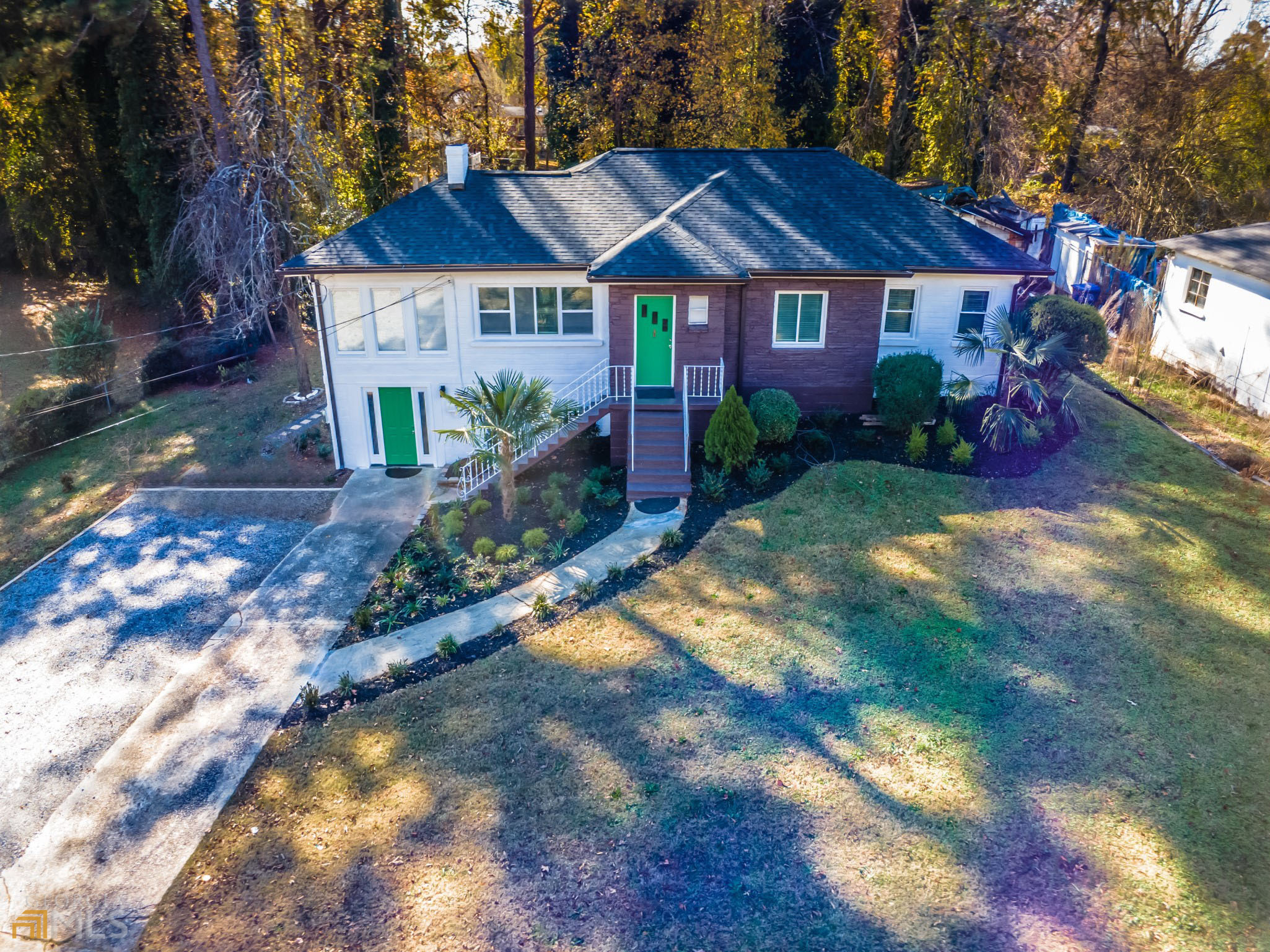 Its a New Year and the owner has drastically reduced the price of this handsome mid-century ranch on close to an acre lot with a full finished lock-out basement. Newly renovated with Stunning landscaping highlighted by lovely needle palm trees and paved walk way to the rear yard. The main level features an open floor plan complete with original hardwood flooring, spacious great room with FP and decorative wall. Kitchen is complete with quartz surfaces and SS appliances that opens into the dining area featuring stunning crystal light fixture. Main level bedroom with en suite has awesome large windows allowing for natural light throughout. Terrace level studio apartment can be used as an in-law suite or rented for income. Area is also equipped with a full kitchen, full bathroom, large interior space accessible from upstairs and exterior access by way of front and rear doors. Minutes to the Beltline, Adams Park, great restaurants and close to I285 and I20! Finished space is larger than what is showing in the tax records. Don't miss this one!