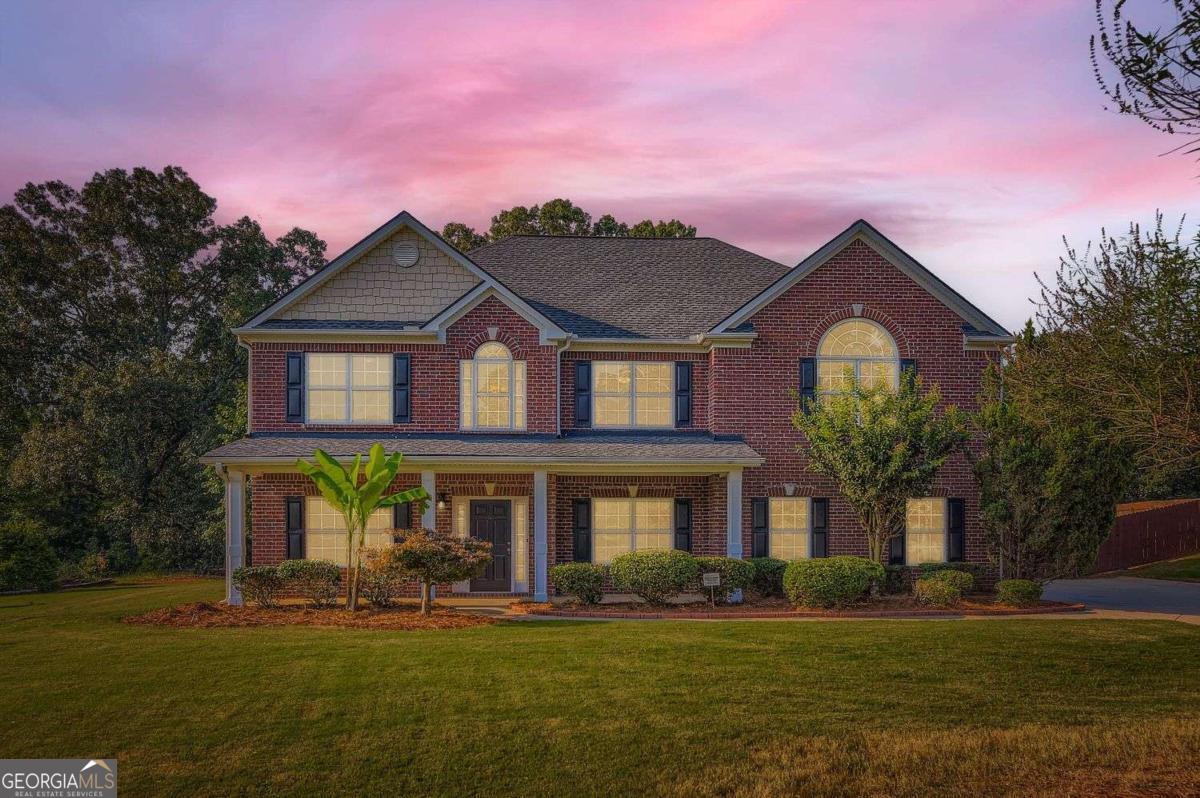 Welcome to this charming 2-story traditional home, perfectly situated on a level, ~1.2 acre lot in a peaceful residential area just outside of McDonough. Boasting classic curb appeal with 3 sides brick and a welcoming front porch, this home offers space, style, and functionality both inside and out. Step inside to find a thoughtfully designed main level featuring a formal living room, a dedicated office space, a separate dining room, and a cozy family room with a fireplace - perfect for gatherings and everyday living. The spacious kitchen is a chef's dream with stained cabinets, granite countertops, a large center island, and all stainless steel appliances included. A convenient half bath and a two-car garage complete the main floor. Upstairs, retreat to the oversized primary suite with an ensuite bath featuring dual vanities, a separate soaking tub, and a walk-in shower. Three additional bedrooms and two full bathrooms provide ample space for family and guests. Enjoy the outdoors from the rear patio, overlooking the expansive, fenced-in backyard - ideal for kids, pets, or entertaining. With a large yard and over an acre of land, there's room to relax, garden, or play. Located in a quiet neighborhood with easy access to both I-75 and I-20, this home offers the perfect blend of country serenity and commuter convenience.
