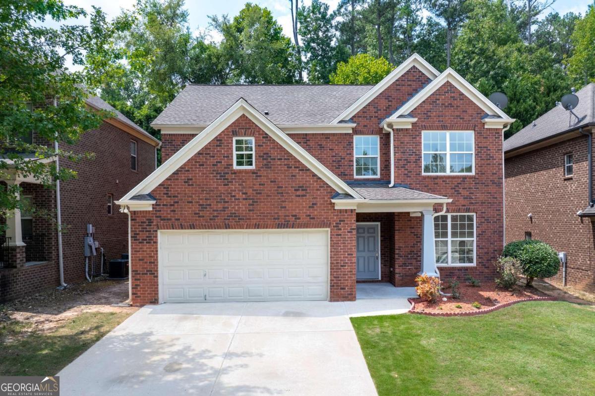 Welcome to this newly upgraded 5-bedroom, 3 full bath home situated in a quiet cul de sac in the heart of Lawrenceville!  This 4-sided brick home features an inviting covered entryway with low maintenance front and backyards.  Upon entering the foyer, look to your right and you'll be greeted with a formal dining room with paneled walls and large double windows bringing in lots of natural light - perfect for memorable meals! Passing from the dining room, the fully upgraded kitchen greets you with brand new Samsung appliances, modern shaker style grey custom cabinetry and durable white with grey marbled quartz countertops.  The open floor plan on the main level allows you to keep an eye on what's happening in the spacious high ceiling family room, complete with gas fireplace for cozy evenings together. The breakfast nook and kitchen bar/counter will ensure informal meals can be ready when you are. The patio for grilling and quiet enjoyment of your backyard is accessed through the door by the breakfast nook. This main level is completed with a guest bedroom (or home office) and a full bathroom/powder room featuring a custom-made tiled walk-in shower with matching grey shaker cabinetry and quartz countertop.  Up the stairs, the high ceilings continue with 3 spacious bedrooms with ample closet space.  A full bath with shower/tub with matching grey shaker cabinetry and quartz countertop, as the main level, compliments these bedrooms.  The laundry adjacent to the full bath features full size Samsung washer/dryer ready for anything you can throw in it and a SPACIOUS walk-in closet for all your linens!  Down the hallway is the HUGE master retreat featuring a remote-controlled ceiling fan.  The spacious walk-in closet is accessed through a well-appointed master bath featuring double vanity quartz countertop sinks, a soaking tub, and a custom-made tiled walk-in shower.  Bring your 4 cars to this beautiful home and park 2 in the garage and 2 in the driveway.  Brushed nickel hardware is installed throughout the house along with energy efficient, warm glo lighting.  This home is perfectly situated minutes from downtown Lawrenceville's shopping and restaurant district with easy access to 316.  Make 521 Garden View Court your home today!