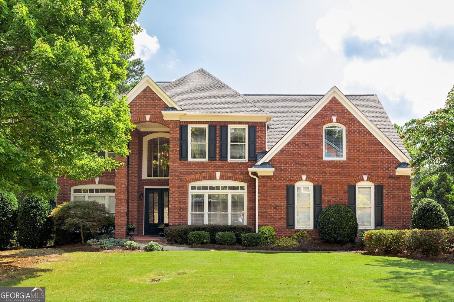 Stylishly remodeled, four-sided brick home in the conveniently located community of Whitehall. Only minutes to GA 400, Perimeter Center, Dunwoody Country Club and a variety of restaurants, parks, and medical services. Excellent schools and lower DeKalb County taxes. Built by John Wieland. Fabulous MAIN LEVEL features two story foyer, many new light fixtures, hardwood floors throughout, vaulted ceilings, and crown moldings. Remodeled kitchen with lots of storage and high-end KitchenAid, Bosch and Thermador appliances, oversized center island, gorgeous granite and new tile backsplash. Family Room features floor to ceiling stacked stone fireplace, and custom bookcases that span the length of the room. The main level is perfectly designed for entertaining! Enjoy a private, covered Trex deck for year-round entertainment featuring tongue-in-groove ceiling, fans, recessed lighting, and a linear gas fireplace with TV connections. UPSTAIRS with four spacious bedrooms, three full baths, hardwoods throughout and convenient laundry facilities. Primary Suite with beautiful bathroom and several spacious custom closets for incredible storage. Remodeled TERRACE LEVEL with home theater/media room, and bar/entertainment area. Fabulous guest suite with bedroom, sitting room and full bath. Additional laundry facilities and more storage. Terrific patio is perfect for grilling, dining, ping-pong and other games. You will love this beautifully remodeled home in this incredibly convenient location!!