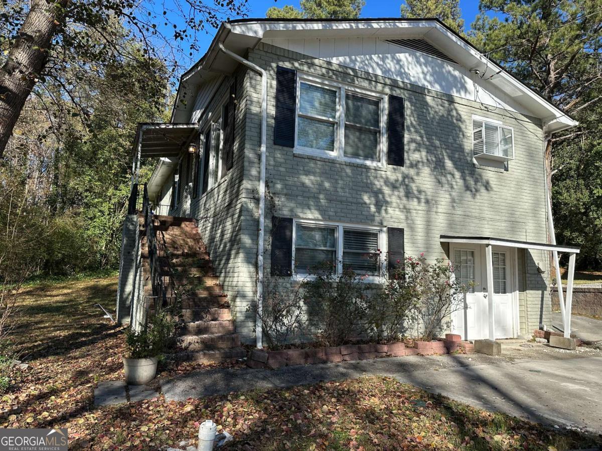 Calling all investors! Welcome to 915 Lake Drive, a 5-bedroom, 2.5-bathroom home with incredible potential, located in the North Lake Shores community in Snellville, Georgia. Built in 1972, this property offers 2,209 square feet of living space, including a finished basement with a cozy brick fireplace, two additional bedrooms, and a full bathroom. The main level features an eat-in kitchen with white cabinetry, laminate counters, and a large family room. Situated on a 0.28-acre lot, this home is perfect for buyers looking for their next investment project. With its proximity to community amenities, including a clubhouse, pool, and fishing dock, and its location near major schools and conveniences, this property offers strong rental or resale potential. Don't miss this opportunity to add value and transform this house into a fantastic income-generating property or flip project.