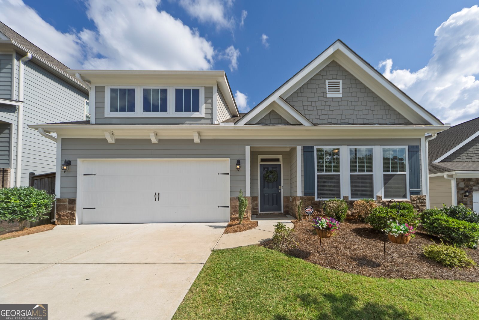 Welcome to your dream home in the desirable Bridgemill Heights - a sought-after newer construction community! This stunning 4-bedroom, 3-bathroom home offers a perfect blend of style, space, and functionality, with the primary suite conveniently located on the main level and a spacious loft/bonus space upstairs. Step inside to find an open-concept floor plan featuring a designer white kitchen with a massive 14-foot quartz island, double ovens and gas range. The kitchen seamlessly flows into the great room, dining area, and breakfast nook - ideal for both everyday living and entertaining. The main level also includes the luxurious primary suite with a spa-like bathroom and oversized walk-in closet, plus two additional bedrooms and a full bath. Upstairs, you'll love the large versatile loft/bonus area, perfect for a media room, playroom, or office, along with the fourth bedroom and third full bath. Enjoy outdoor living in the private backyard with a pergola, providing the perfect shaded space for relaxing or entertaining. Conveniently located across from Sixes Elementary and just down the road from the brand-new Cherokee Classical Academy, with King's Academy also close by. Enjoy quick access to both Downtown Woodstock and Downtown Canton, The Outlet Shoppes, and Hobgood & JJ Biello Parks/Sports Complexes. Outdoor enthusiasts will love nearby Lake Allatoona and the many hiking and biking trails, while commuters will appreciate the easy access to I-575. HOA includes lawn maintenance and trash pickup. Optional Bridgemill membership for access to top-tier resort style amenities: pools, tennis, golf and more! Don't miss making this practically new construction home yours today!
