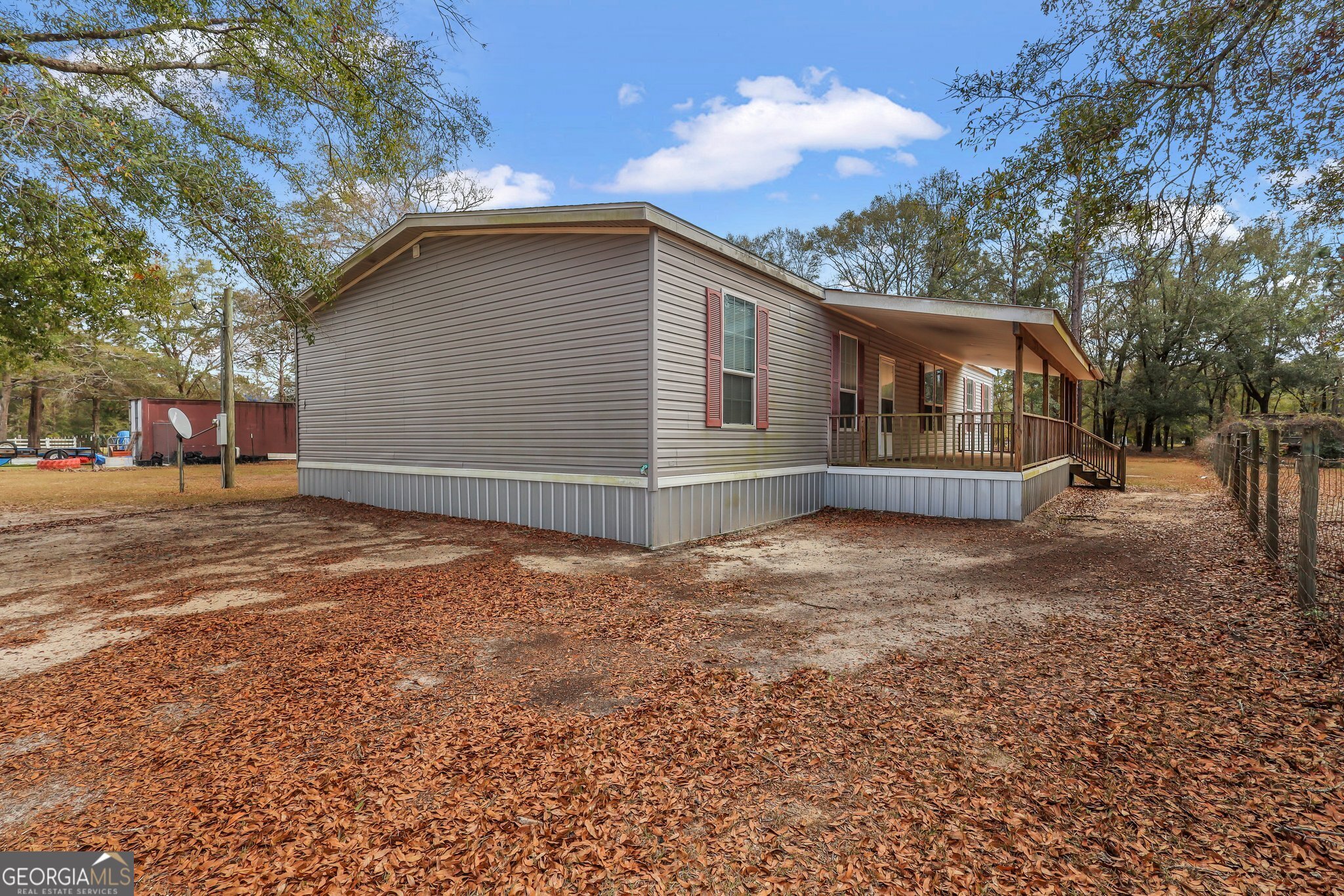 MOVE IN READY! Spacious "Homes of Merit" Manufactured home sits on one-acre lot. Featuring four bedrooms, two baths, an open floor plan, and abundant natural light. All appliances are included, along with second refrigerator in Laundry Room. Dishwasher replaced in 2023. Washer & dryer included. The Metal Skirting around home was added in 2021. Surrounded by mature trees and nature, this property is conveniently located near shopping, restaurants, and schools. Ample space for RV and/or boat parking. The septic tank was pumped in 2023, Well inspected by Woodrow Sapp Co in 2023. Termite Bond with Incredible Pest. Property is clean and move in ready! Located in USDA Financing Area. Easy to show!