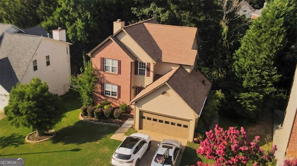 Fully finished basement with a separate entrance, complete with a kitchen and living room-perfect for guests or multi-generational living. Located in the highly sought-after Peachtree Ridge school cluster. Enjoy a beautiful back deck and a brand-new kitchen with granite countertops, stainless steel appliances, and a gas cooktop. Freshly painted interior and a roof replaced in 2023. This home features a stunning two-story foyer, a spacious family room with a fireplace, and a gorgeous sunroom with abundant windows that bring in natural light. The maintenance-free backyard is ideal for easy living. Conveniently located with quick access to Atlanta, Duluth, I-85, and I-985, commuting is effortless. Shopping and dining are just a short walk away-don't miss this opportunity to own a beautiful, move-in-ready home in an unbeatable location! Priced to sell.